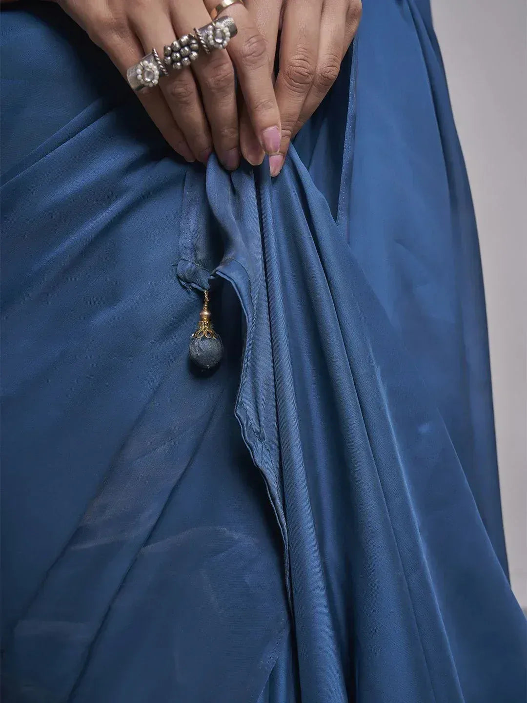 Blue silk saree with tassel detail, styled with ethnic rings for Indian ethnic wear