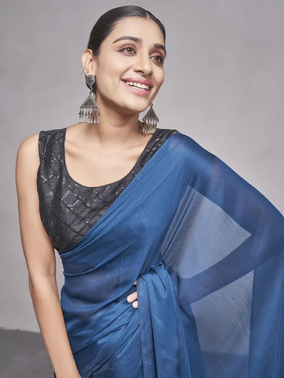 Woman in blue saree with black sequin blouse, ethnic Indian wear, stylish traditional outfit