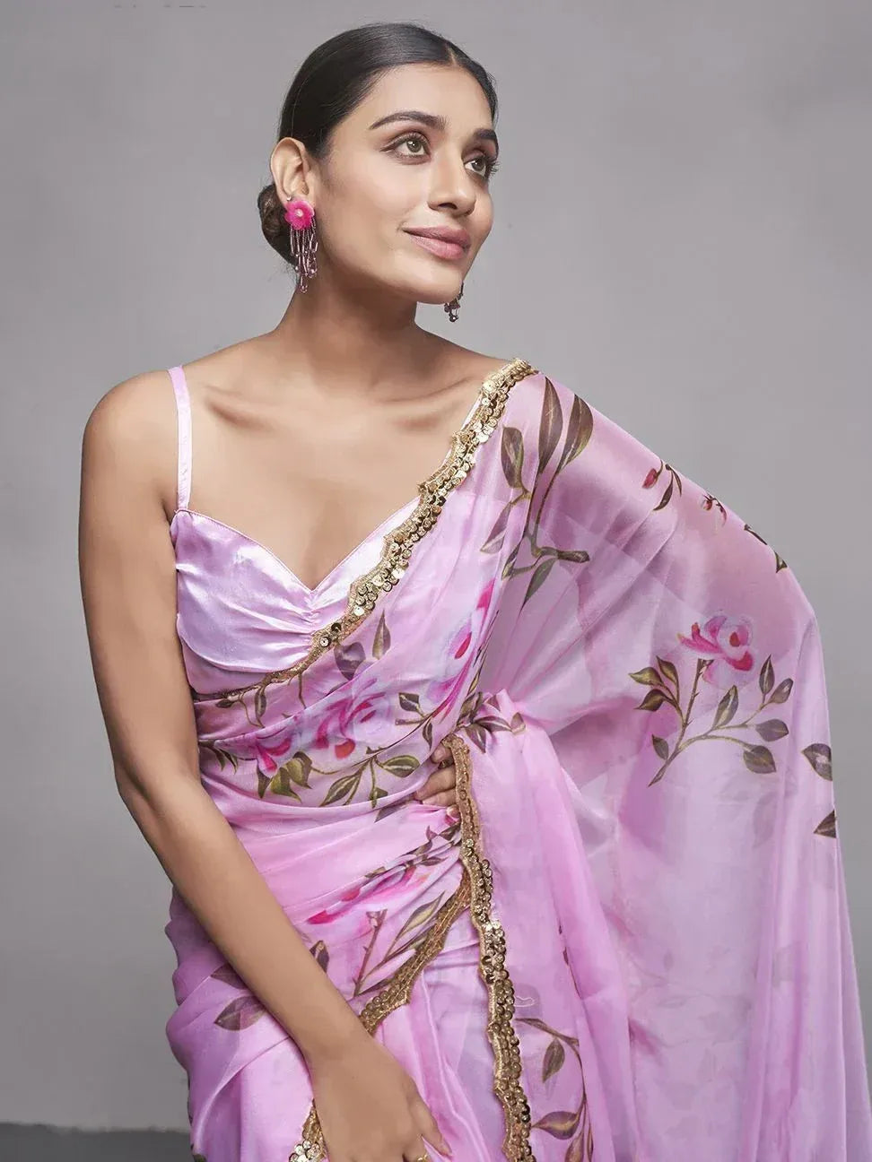 Pink floral saree with gold trim, styled with spaghetti strap blouse for ethnic wear