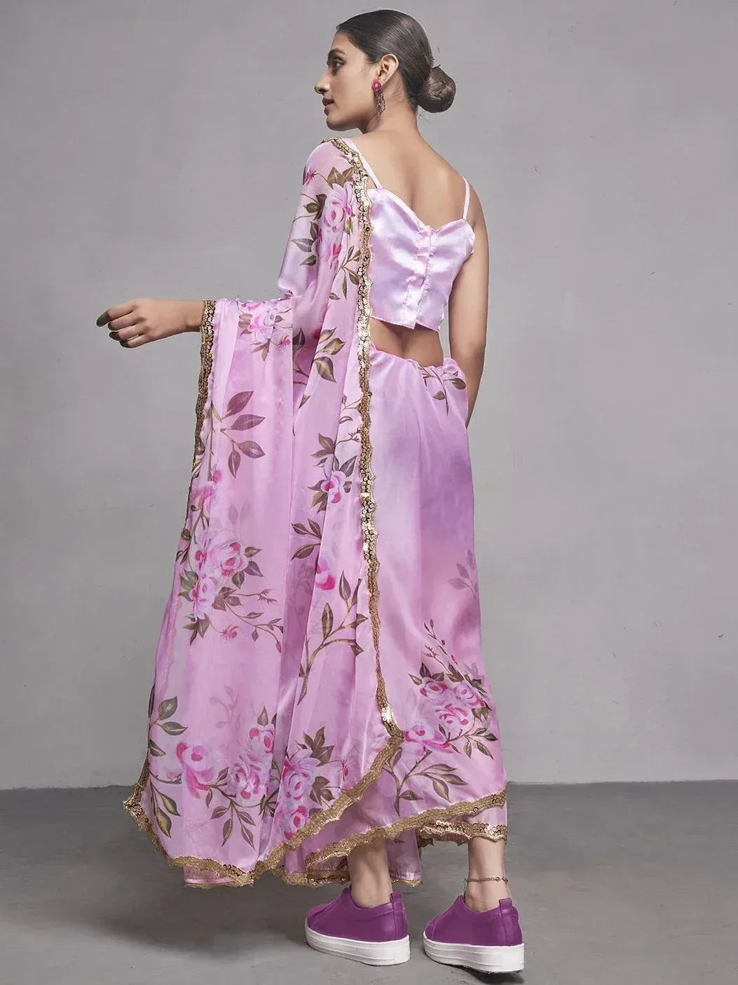 Pink floral printed ethnic gown with gold trim, back view, paired with purple sneakers