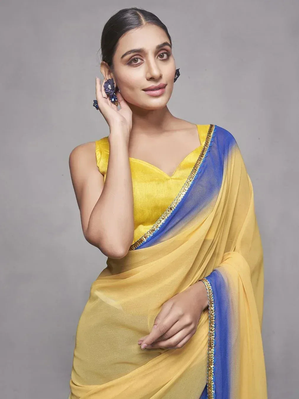 Yellow and blue designer saree with gold border, perfect for ethnic occasions