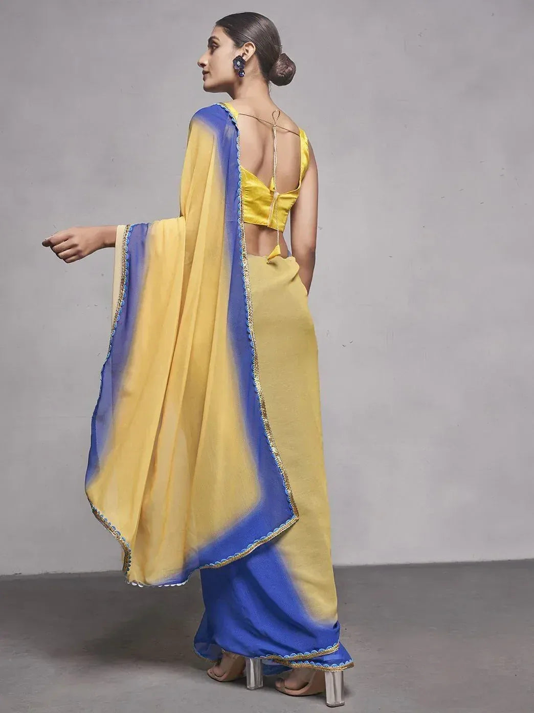 Yellow and blue ethnic saree with backless blouse and scalloped dupatta, perfect for Indian occasions