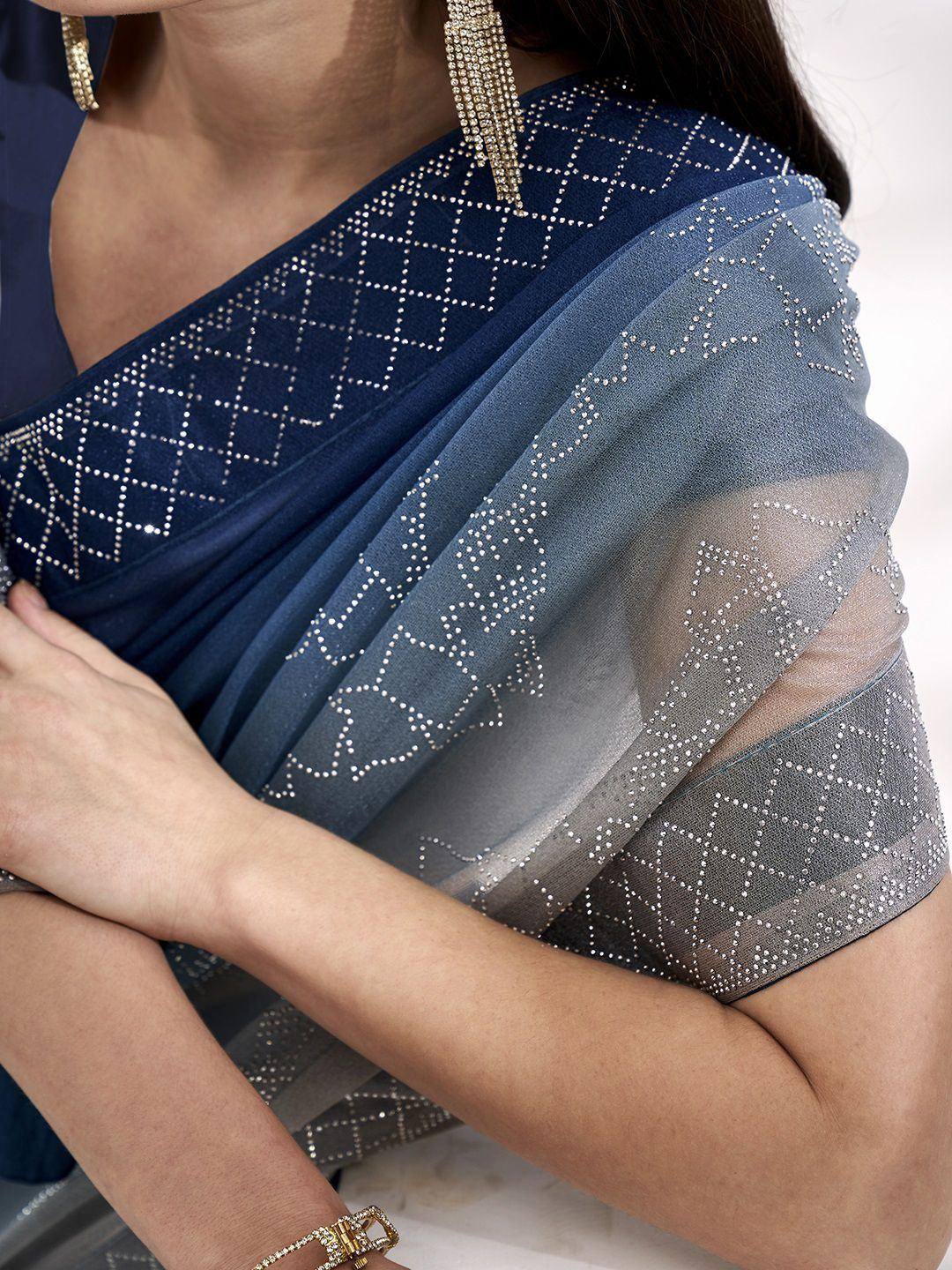 Navy blue saree with geometric sequin embroidery, sheer overlay, and gold jewelry