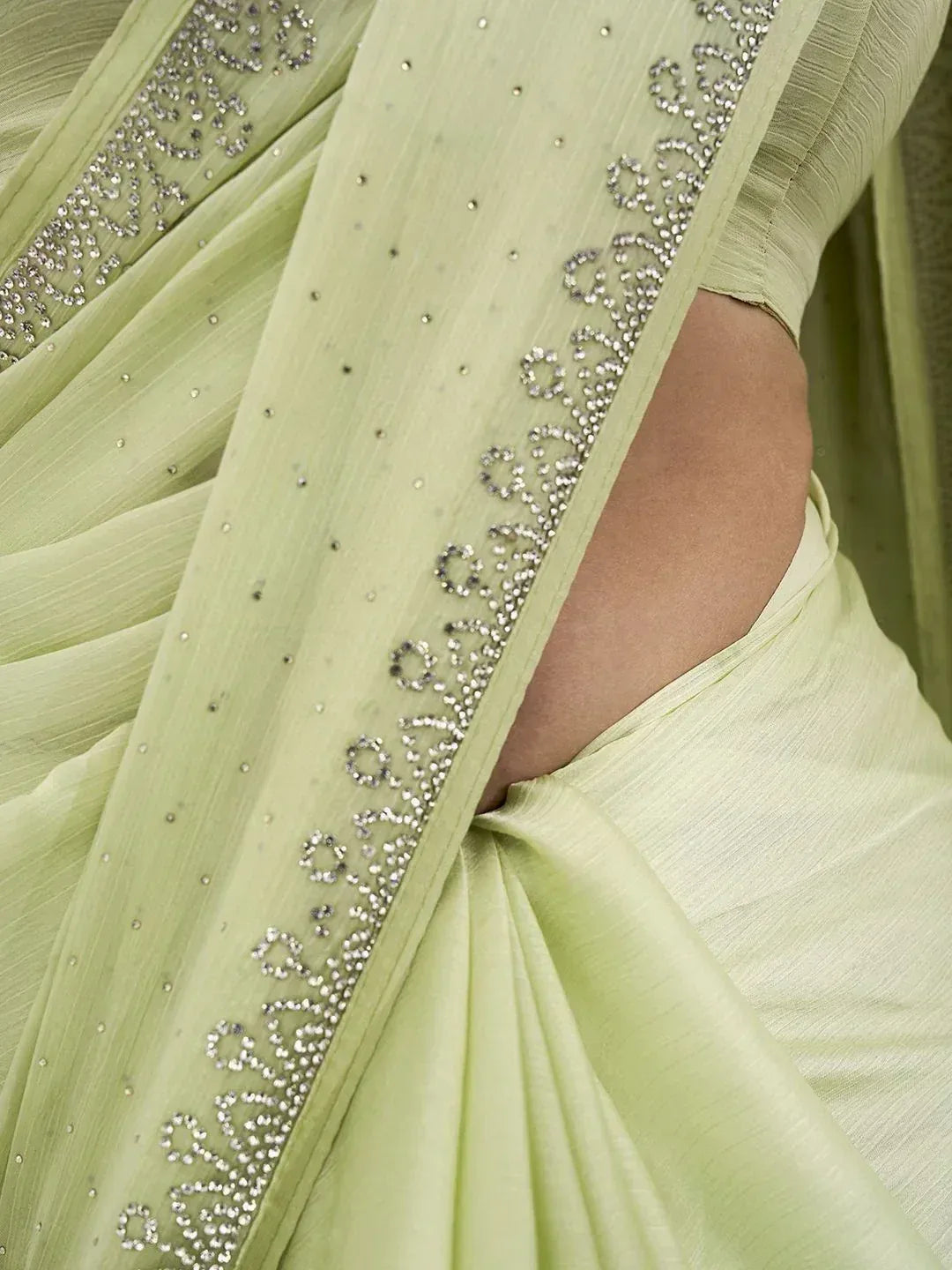 Light green saree with intricate silver beadwork and sequin border, elegant ethnic wear