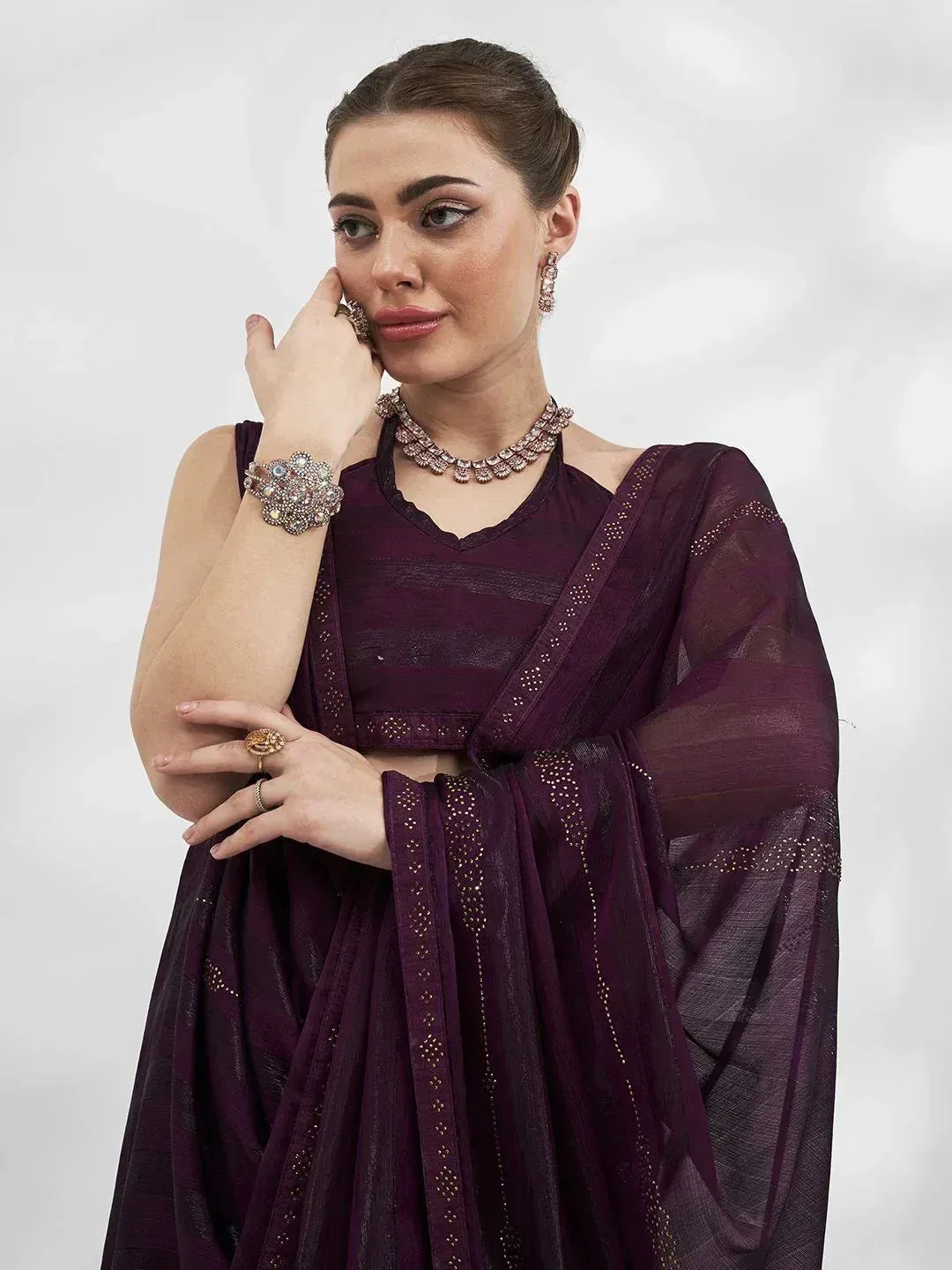Elegant purple designer lehenga choli with intricate embroidery and traditional jewelry