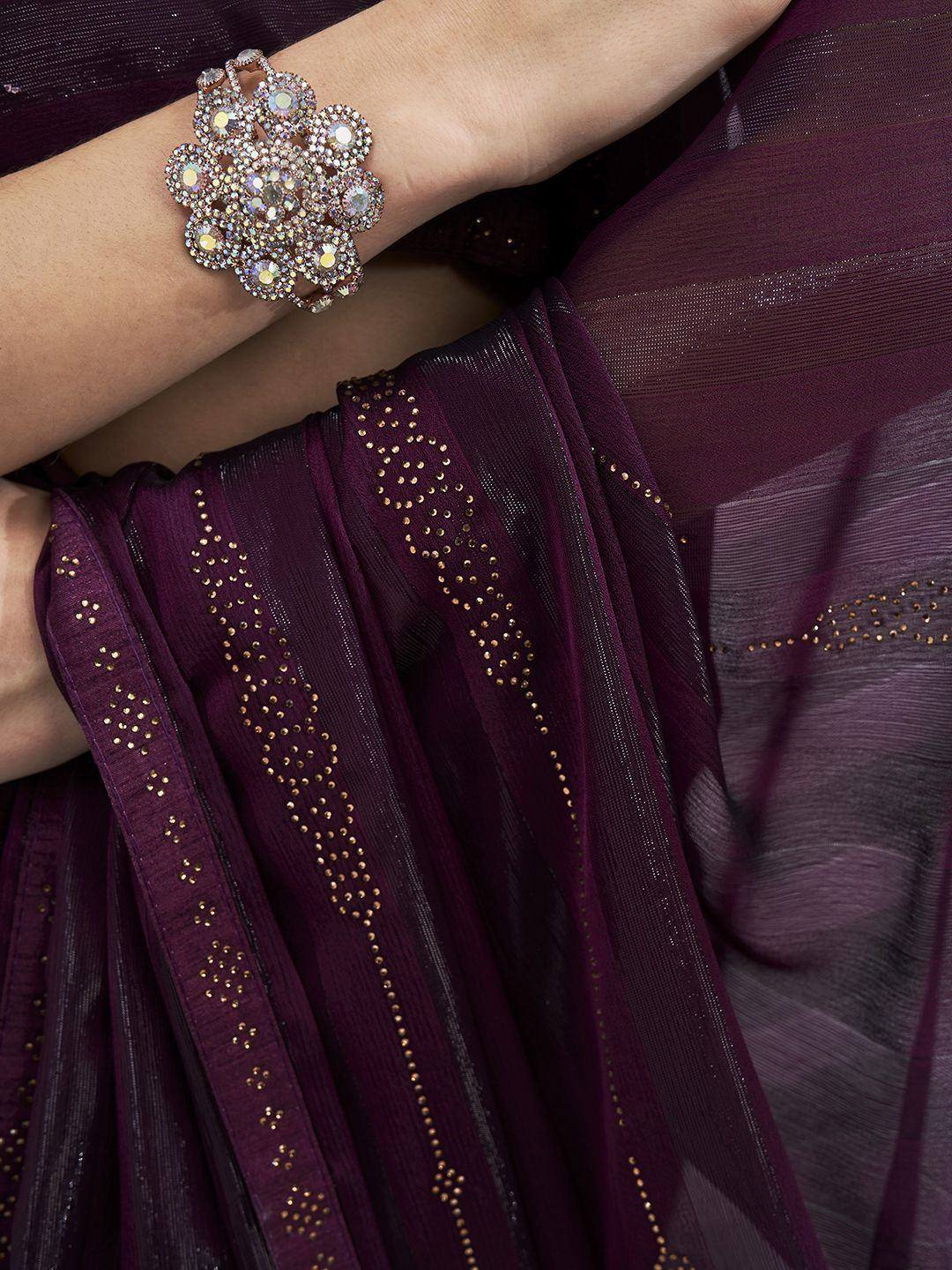 Elegant purple ethnic gown with gold dot embroidery and sparkling floral bracelet
