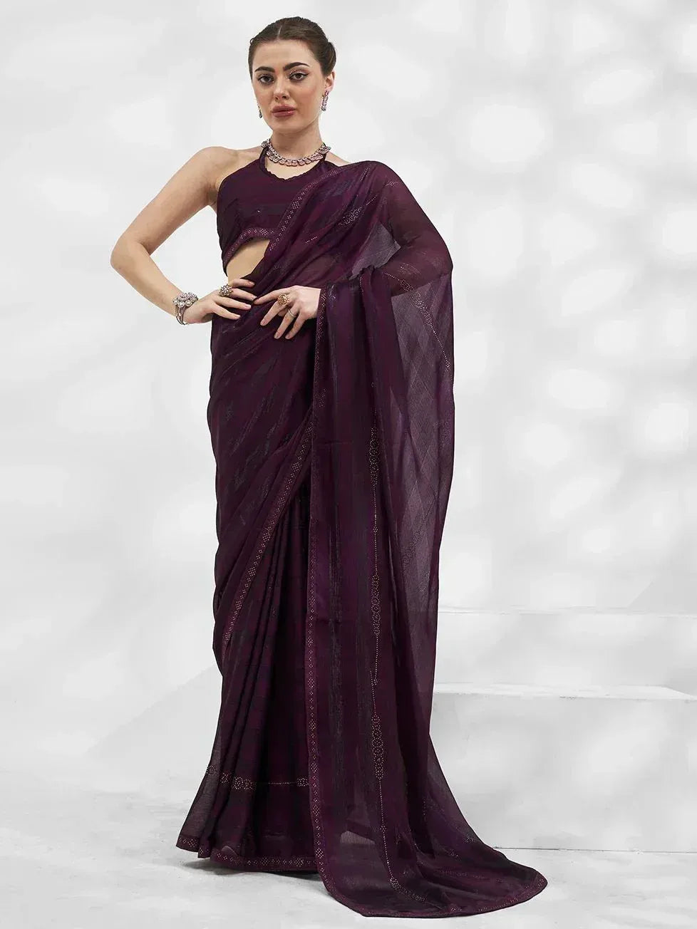 Elegant purple designer saree with sheer blouse, perfect for Indian ethnic wear occasions