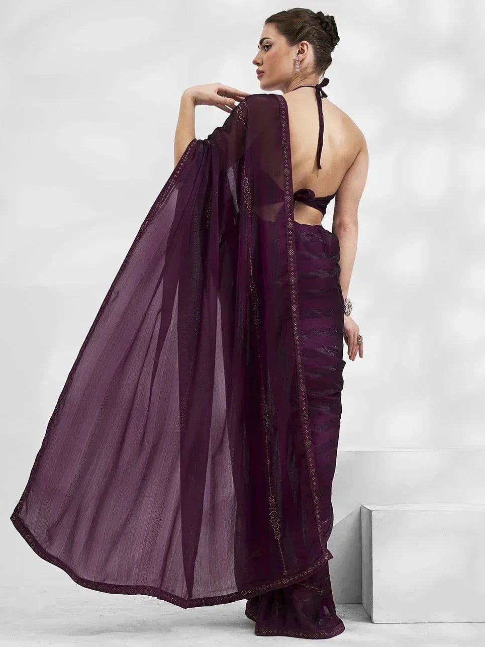 Elegant purple saree with sheer blouse and backless design, perfect for ethnic occasions