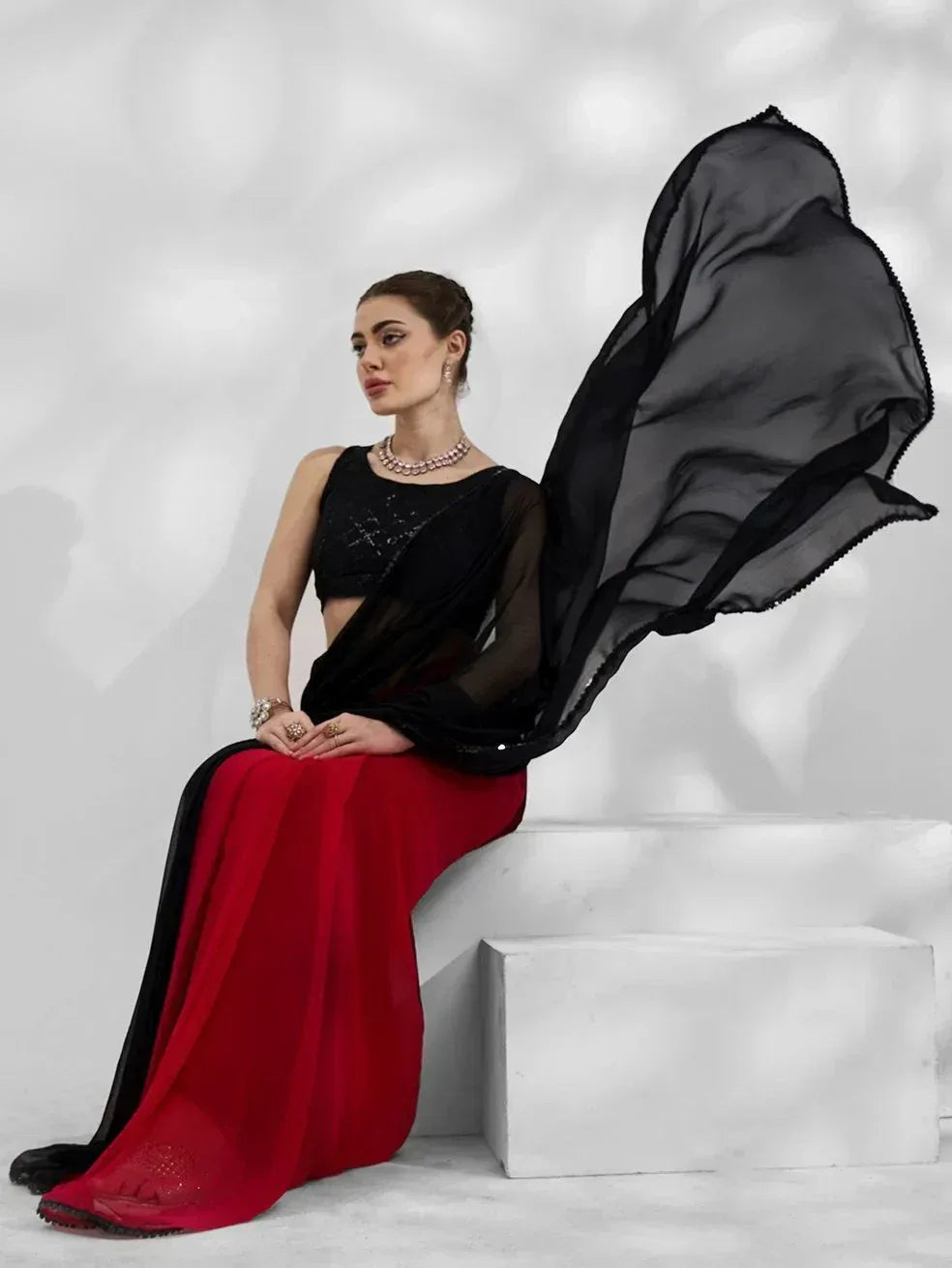 Elegant black and red saree with sequin blouse, perfect for Indian ethnic wear occasions.