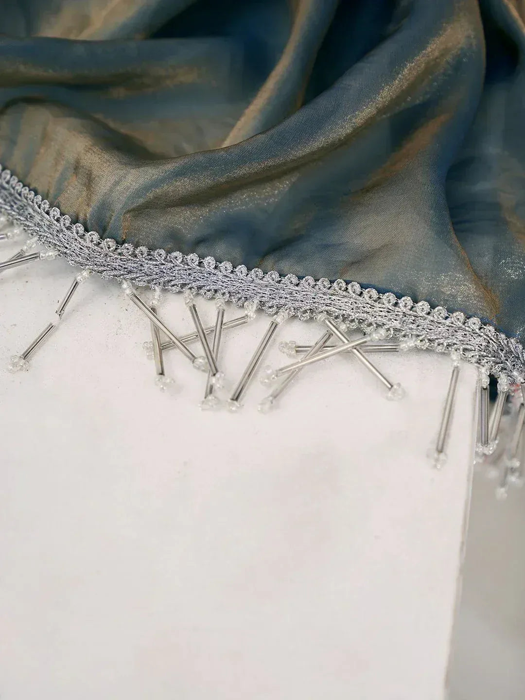 Blue ethnic saree with silver beaded border and tassels, designer Indian wear detail