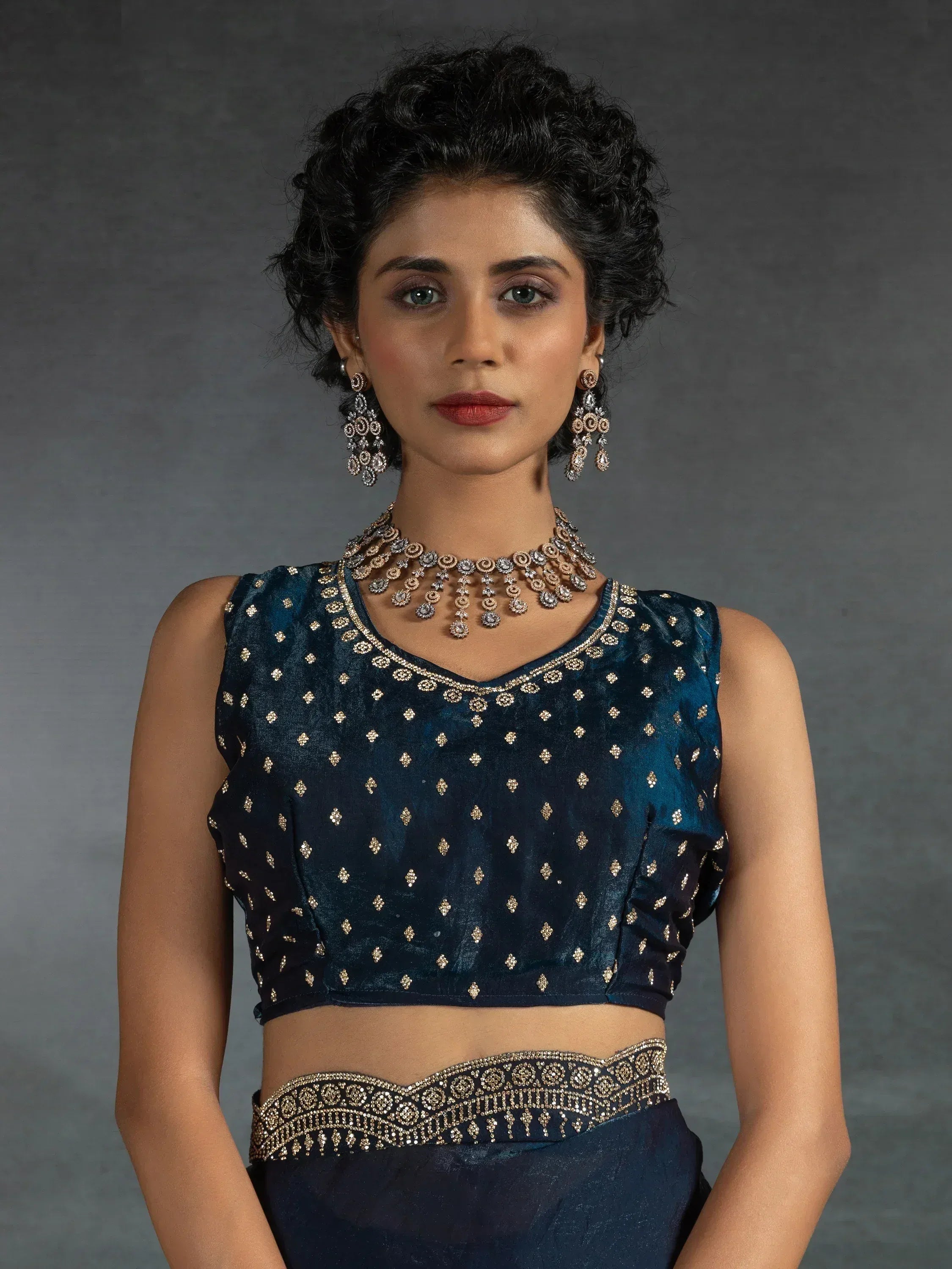 Elegant navy blue ethnic blouse with gold embroidery and matching jewelry