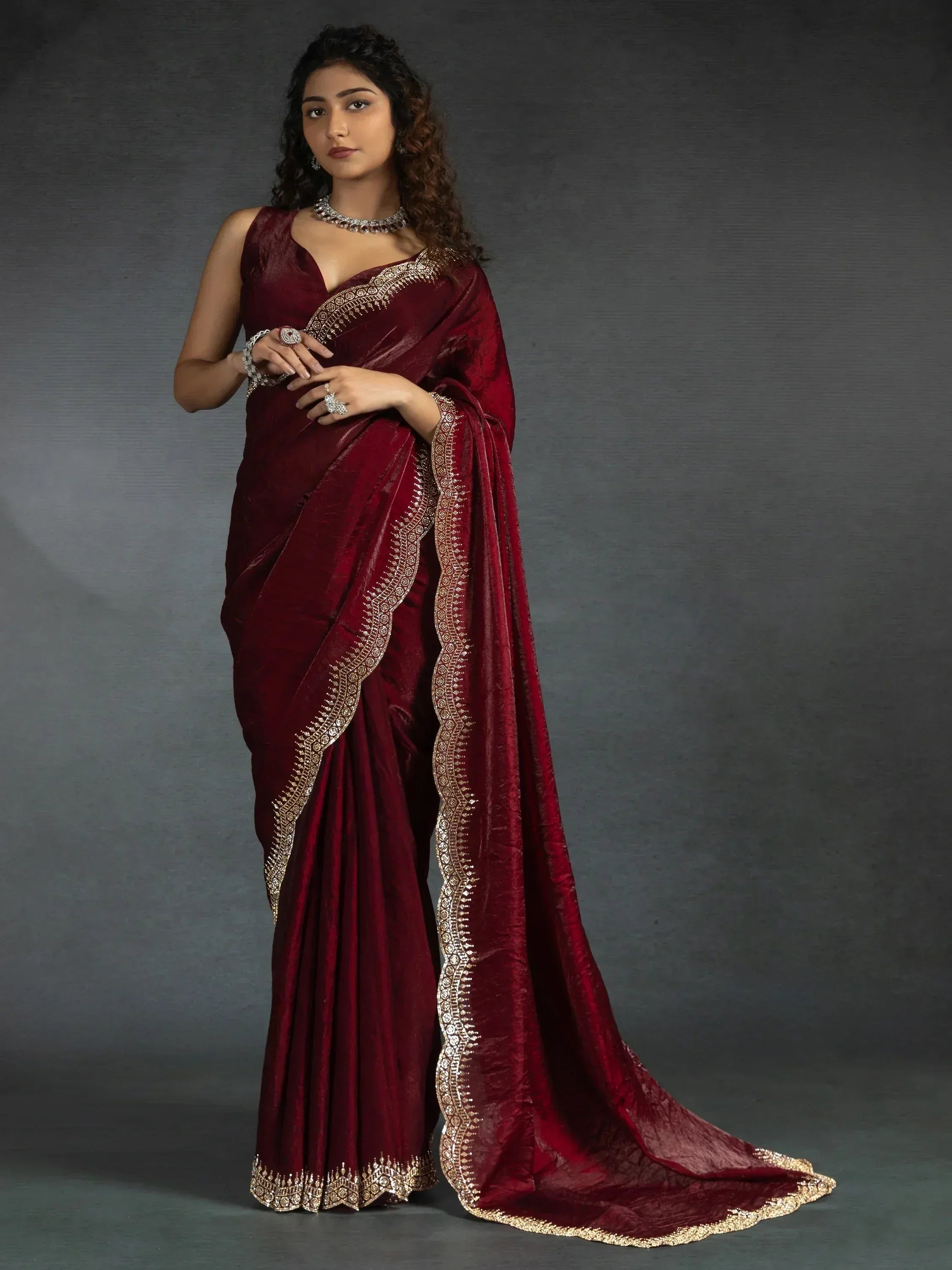 Elegant maroon saree with gold embroidery, perfect for Indian ethnic wear occasions