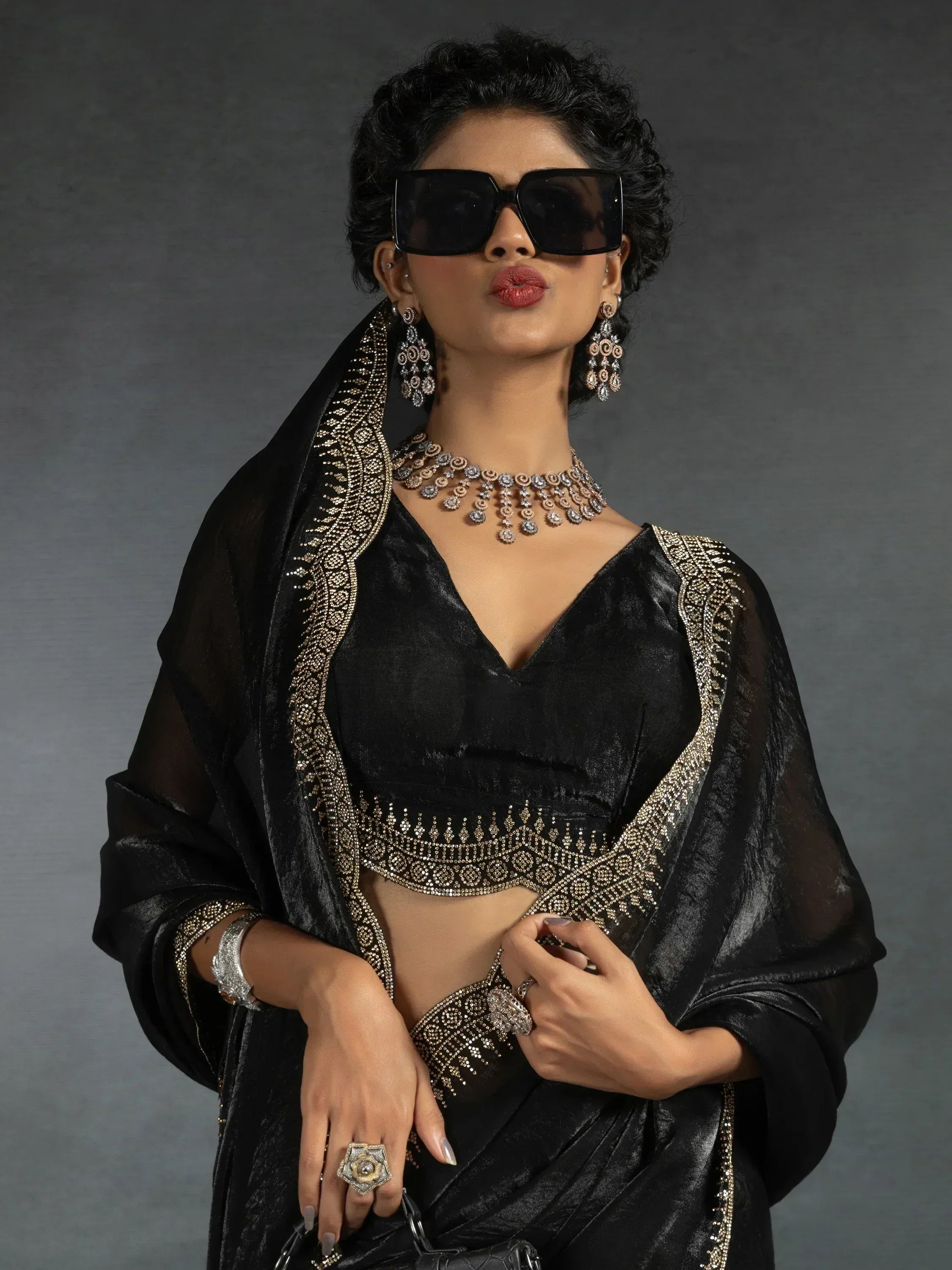 Black velvet ethnic blouse with gold embroidery, paired with matching dupatta and statement jewelry