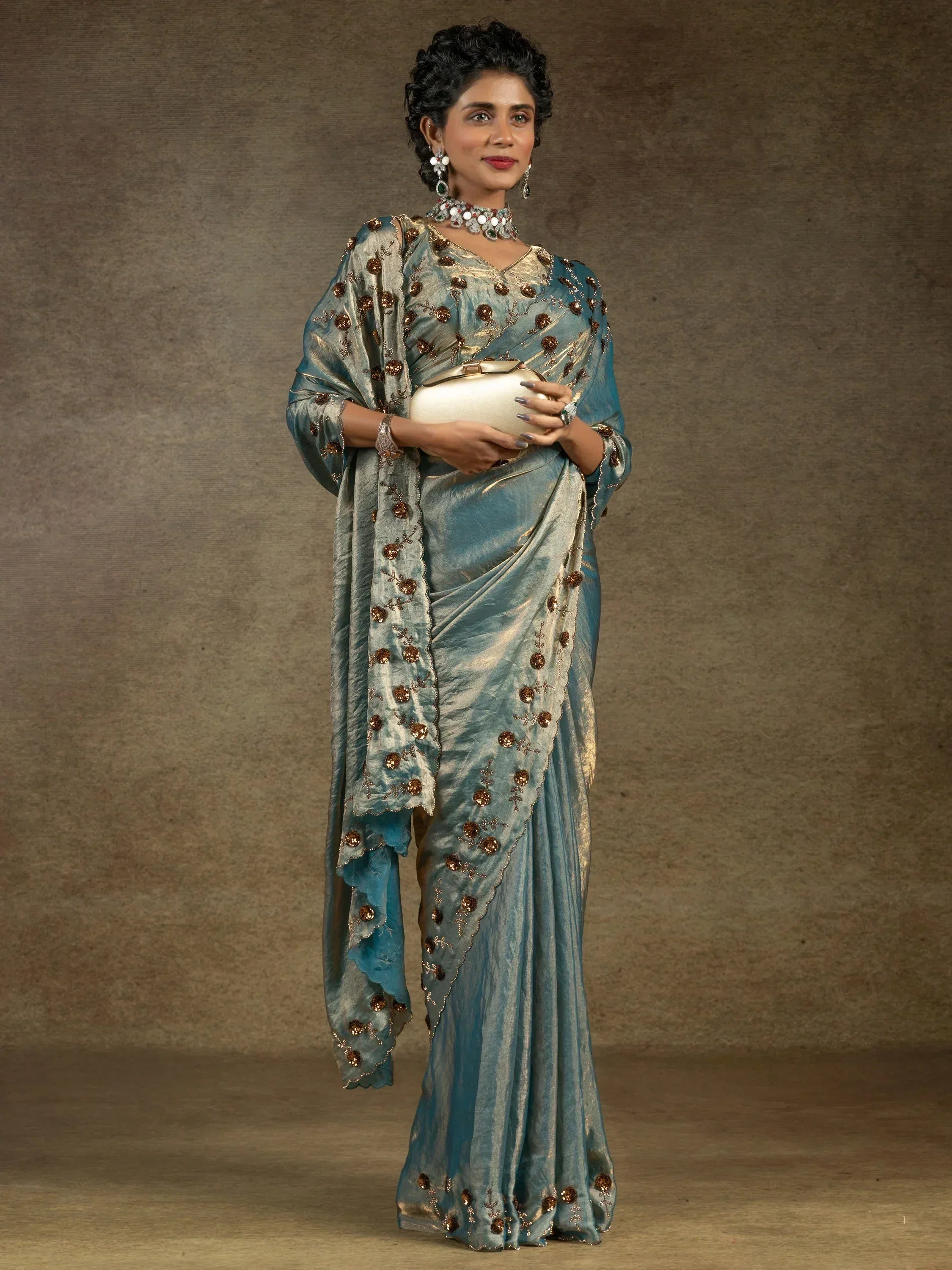 Elegant teal saree with gold floral embroidery, perfect for Indian ethnic wear occasions