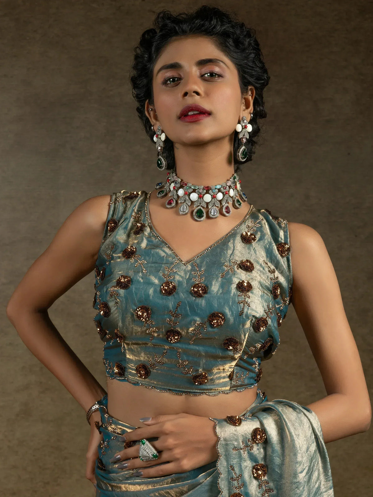 Elegant teal lehenga choli with gold embroidery and gemstone jewelry for Indian ethnic wear