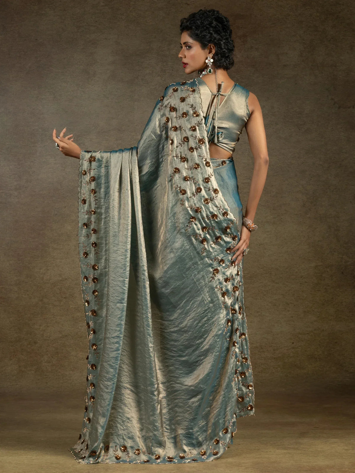 Elegant teal saree with golden floral embroidery and stylish blouse for ethnic wear