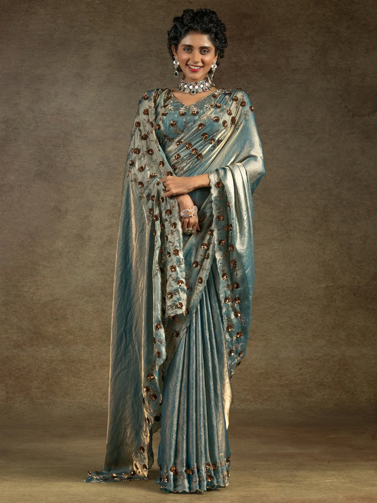 Elegant blue saree with golden floral embroidery, perfect for Indian ethnic wear occasions.