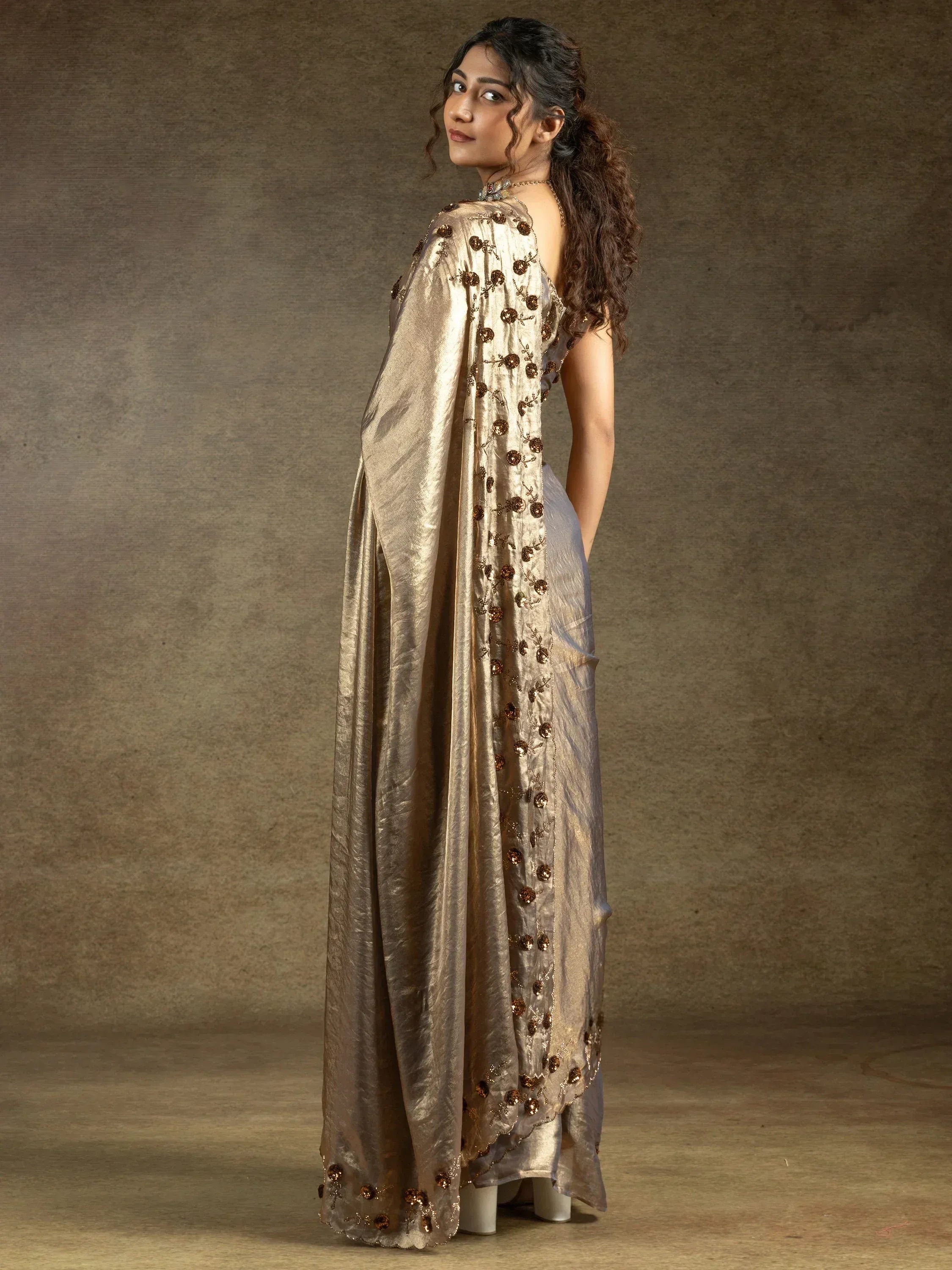 Elegant gold embroidered saree with floral detailing, perfect for Indian ethnic wear occasions.