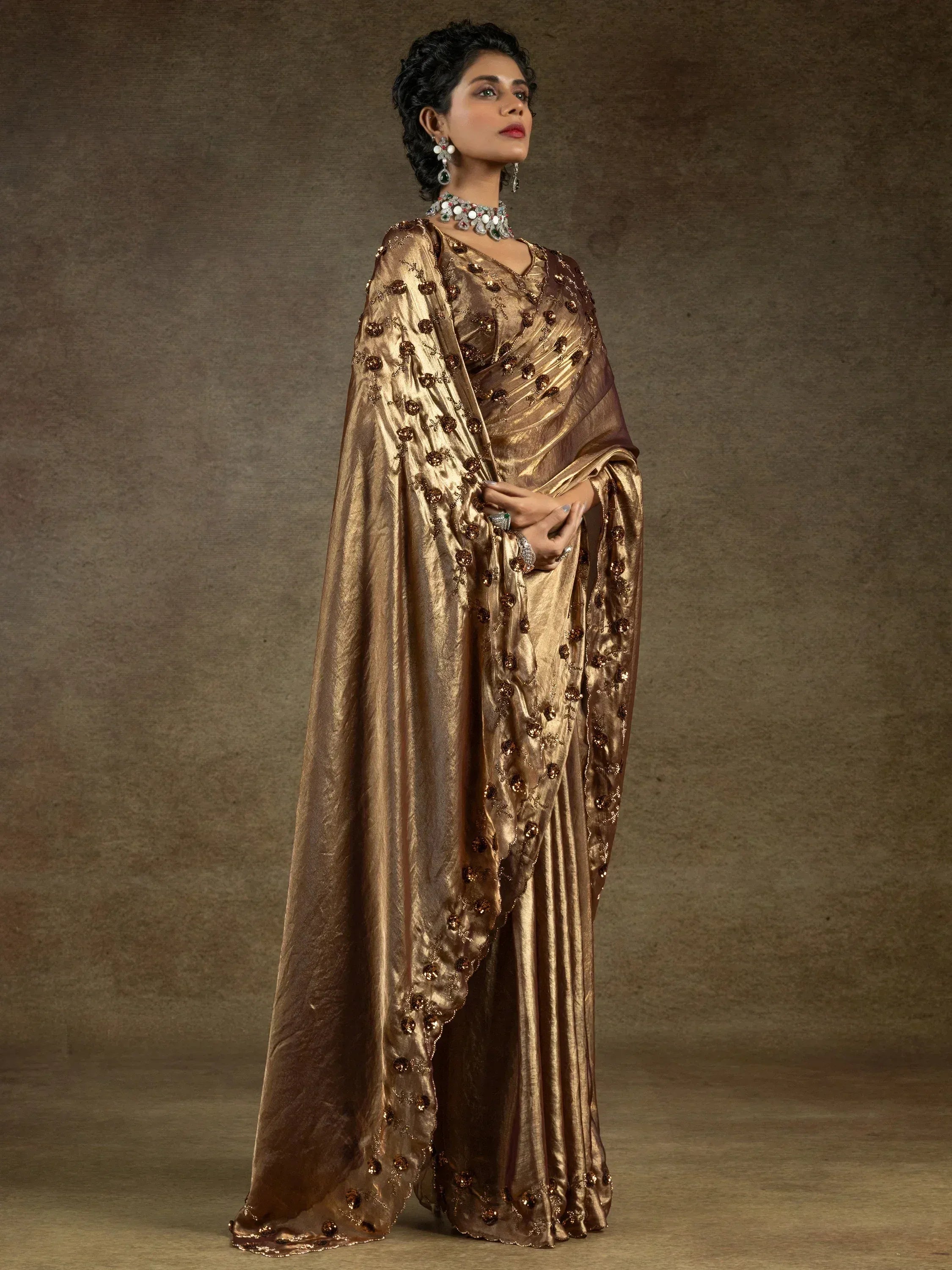 Elegant gold embroidered saree with floral embellishments, perfect for Indian ethnic wear occasions.