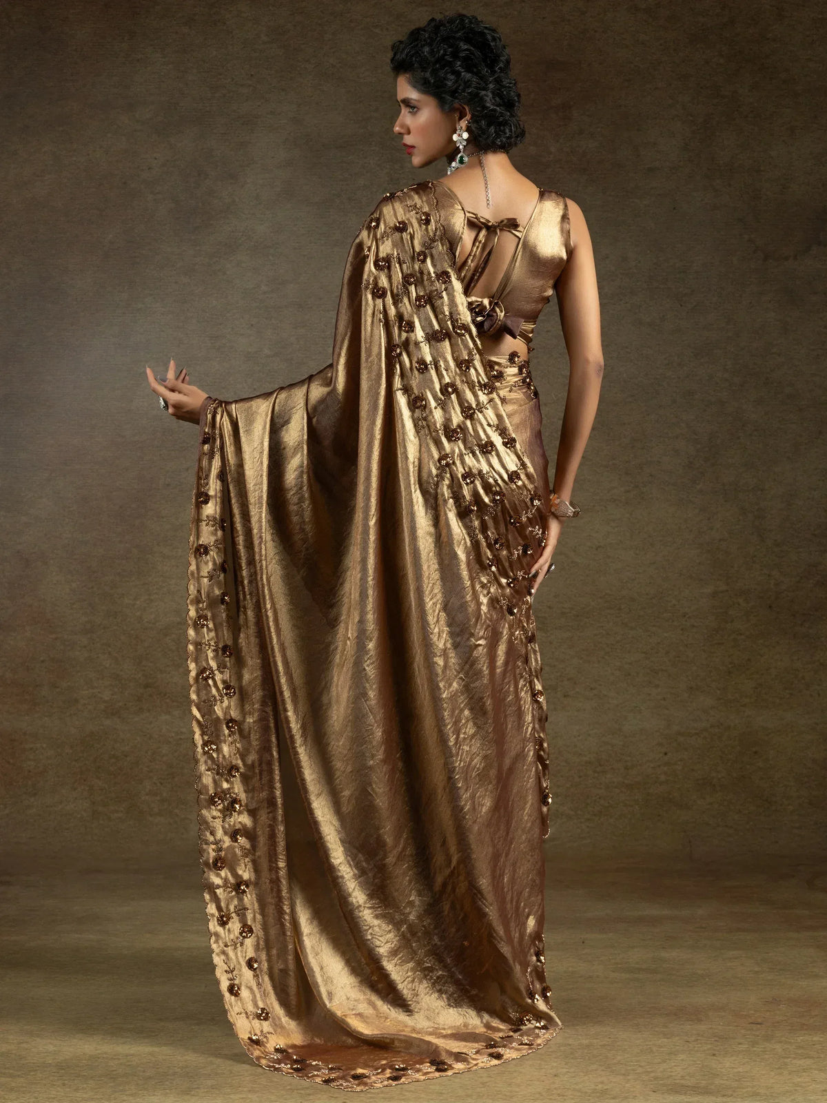 Elegant gold saree with floral embroidery, perfect for ethnic occasions and festive wear.