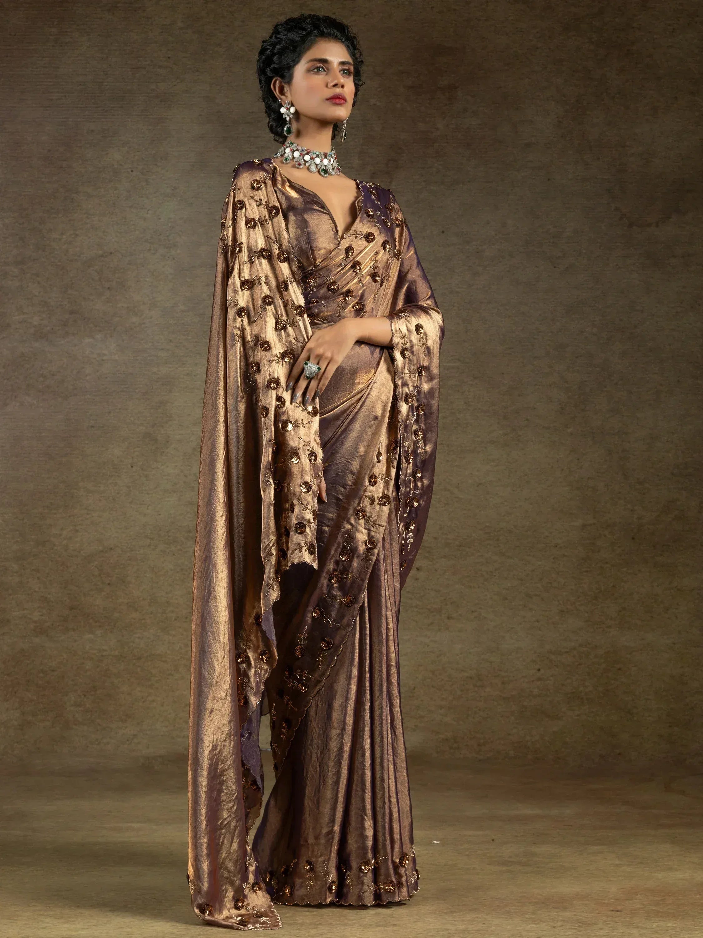 Elegant brown saree with floral embroidery and shimmering fabric, perfect for ethnic occasions.