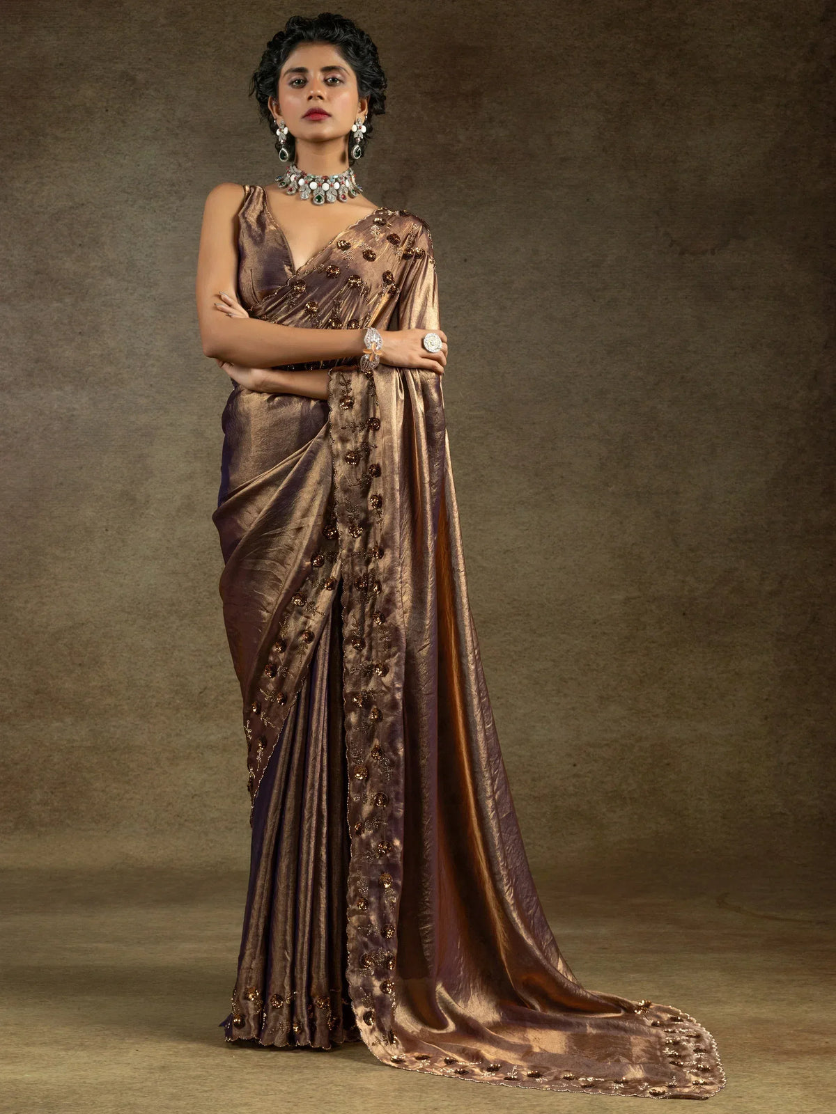 Elegant brown saree with golden embellishments and traditional jewelry for ethnic wear