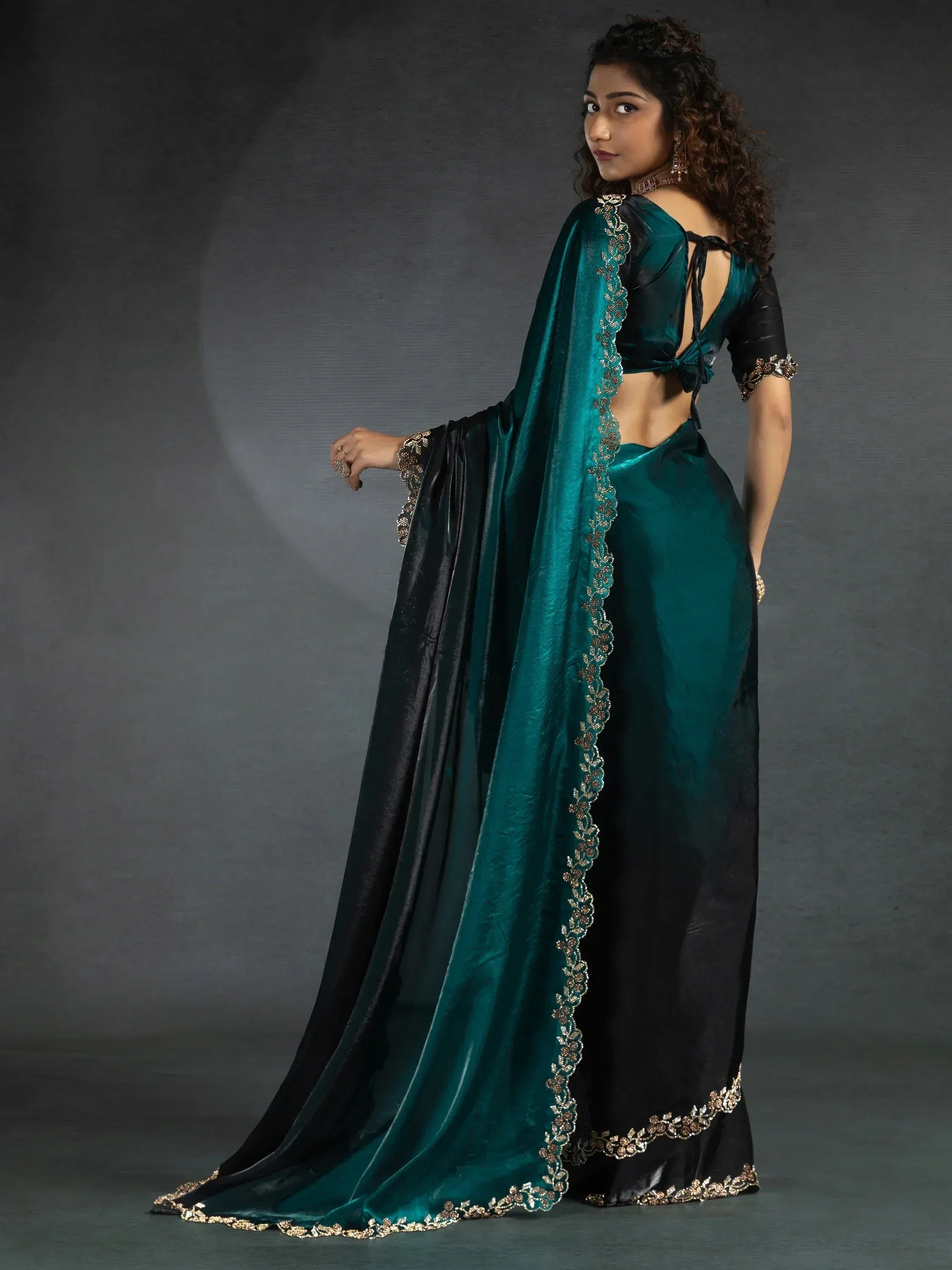Emerald green and black saree with gold embroidery, perfect for ethnic occasions