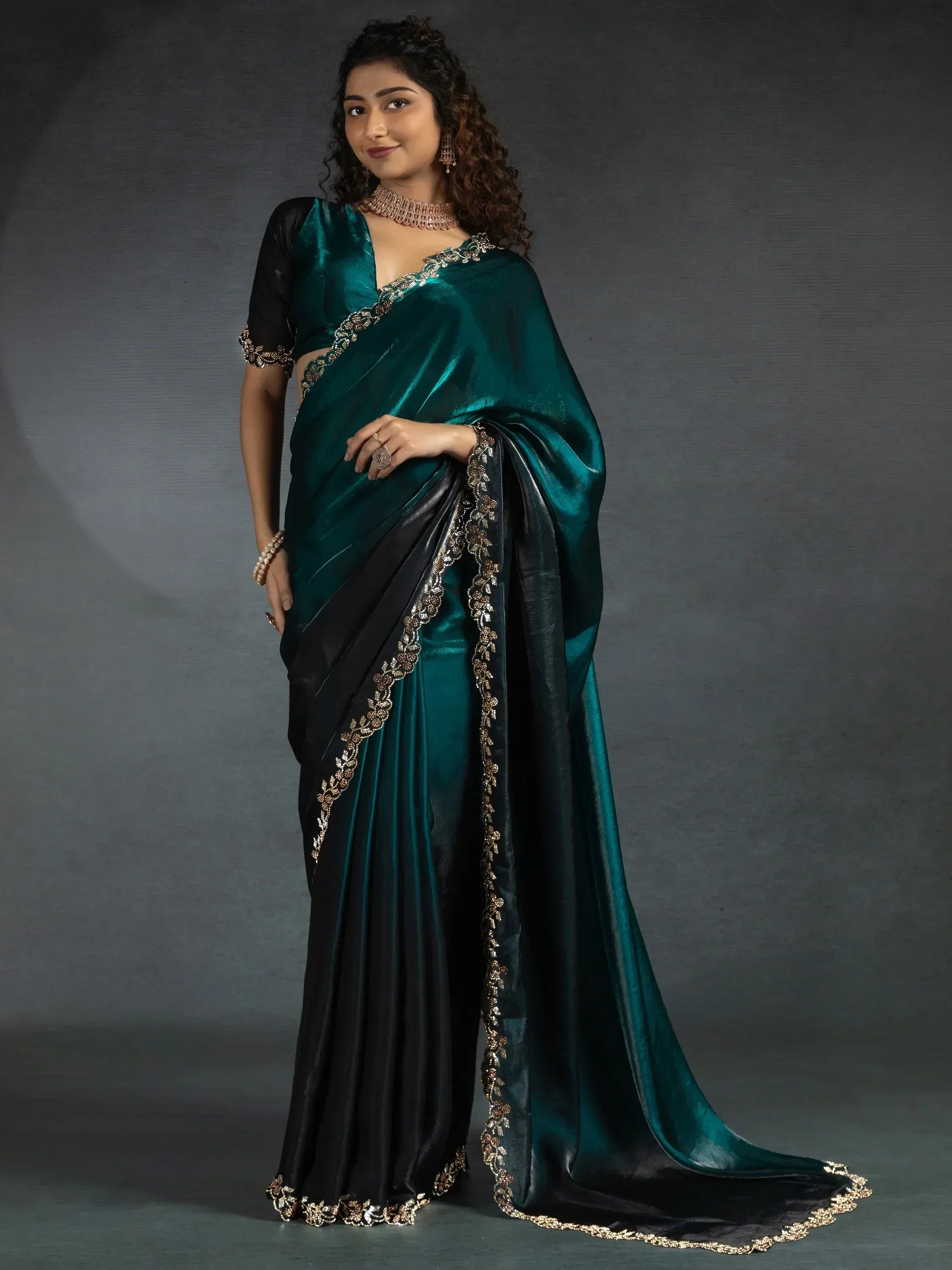 Emerald green and black saree with gold embroidery, perfect for ethnic occasions