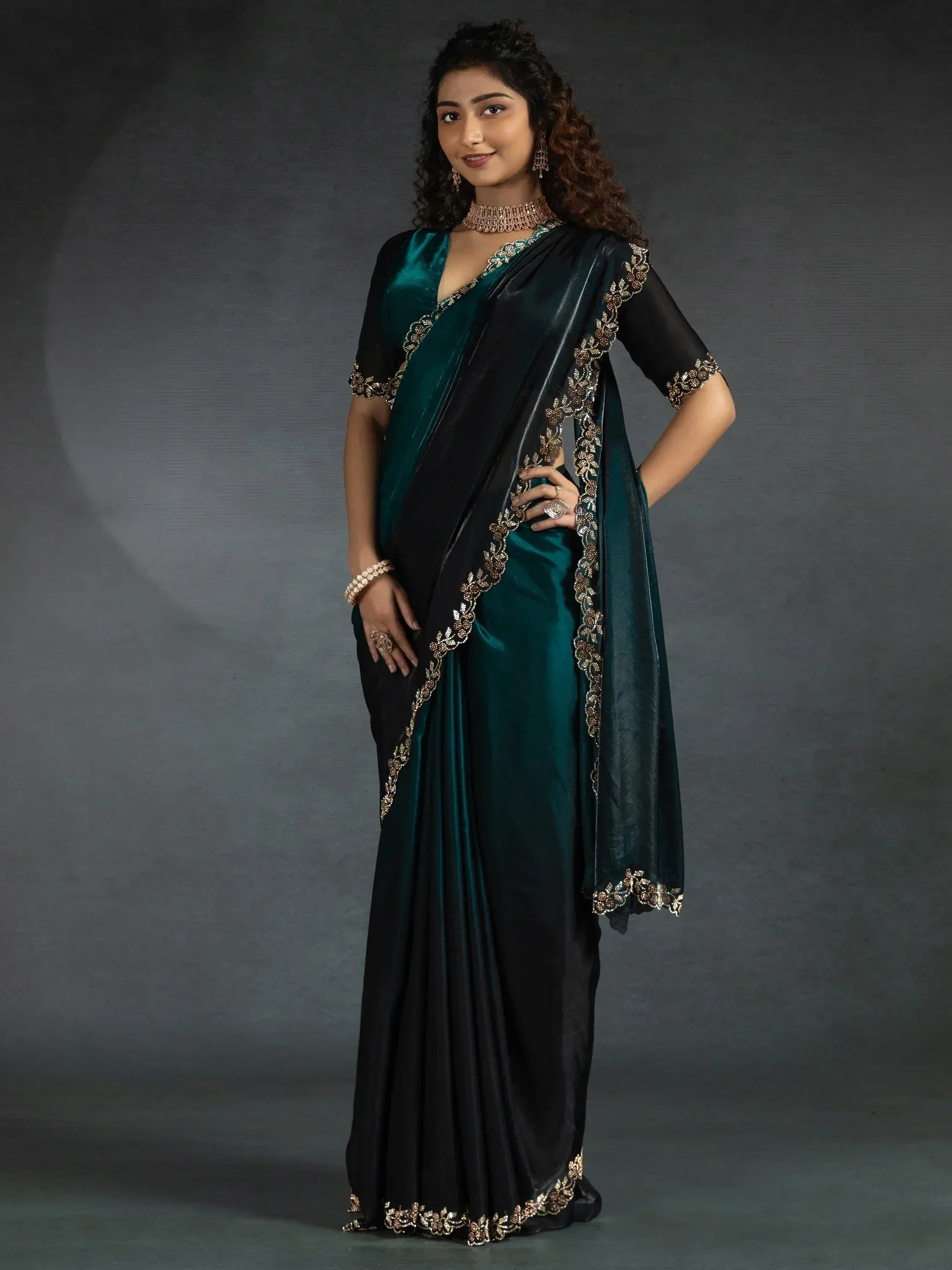 Elegant teal and black saree with gold embroidery, perfect for ethnic occasions