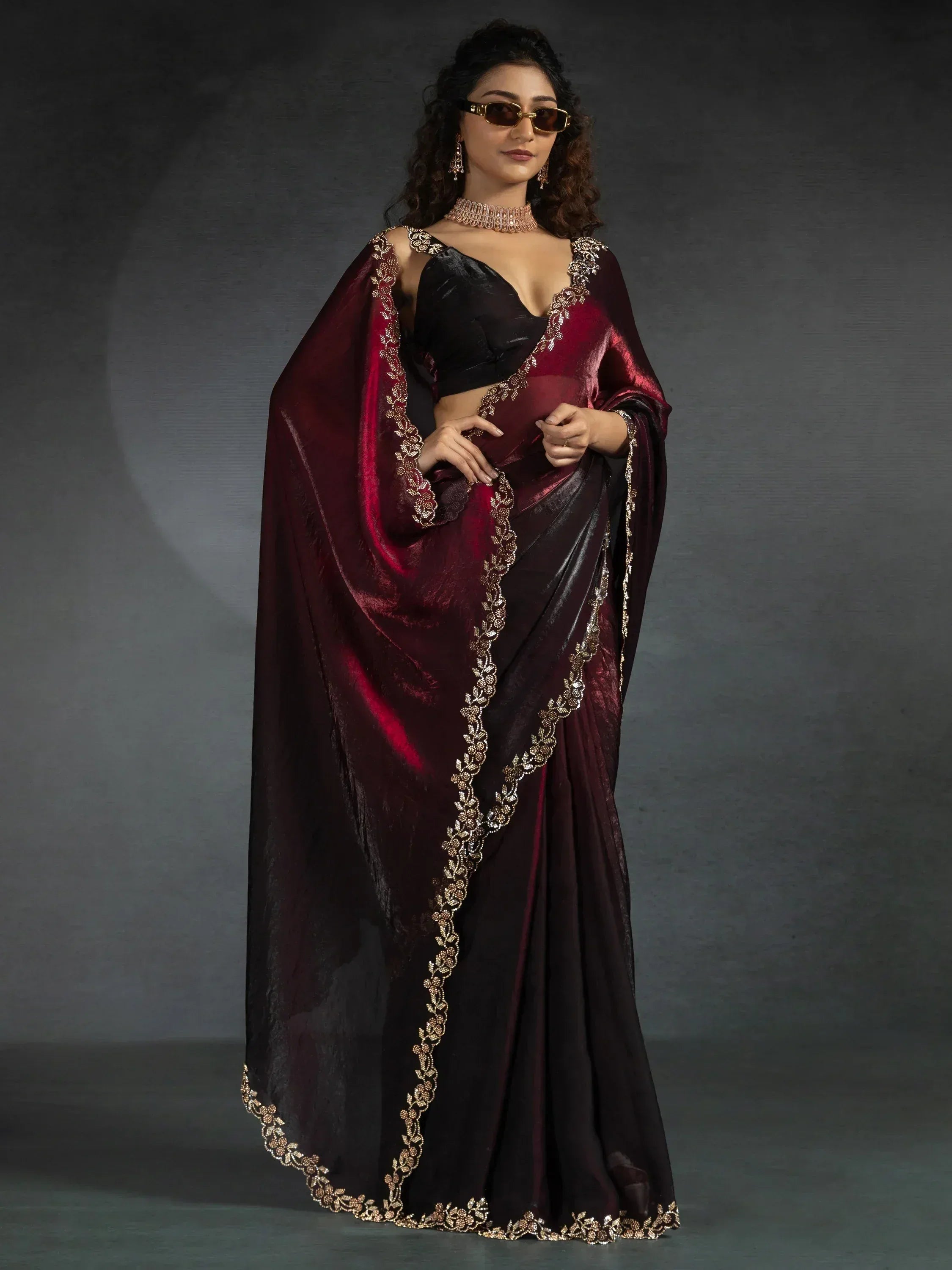 Elegant maroon and black saree with gold embroidery, perfect for Indian ethnic wear occasions.