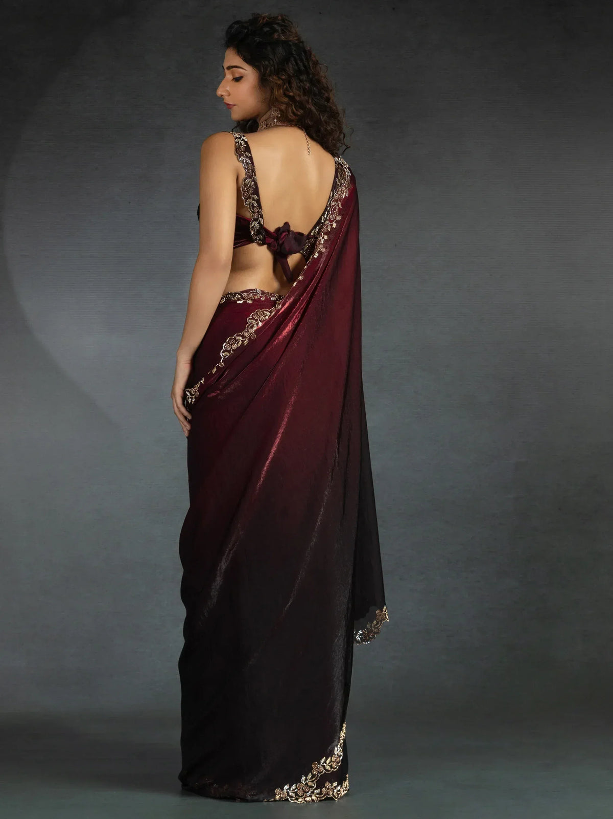 Elegant maroon saree with gold embroidery and backless blouse design