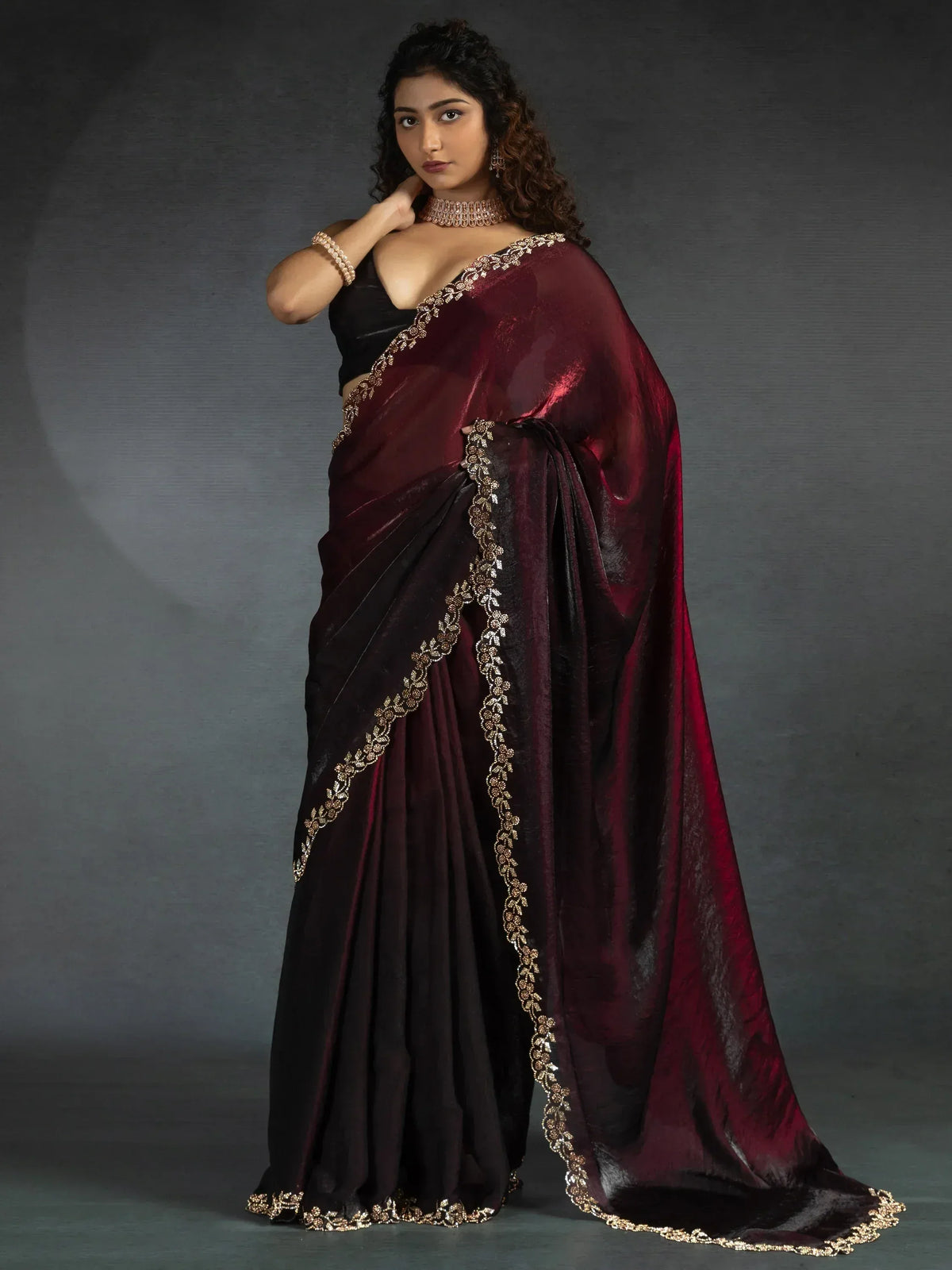 Elegant maroon and black saree with golden embroidery, perfect for Indian ethnic wear occasions.