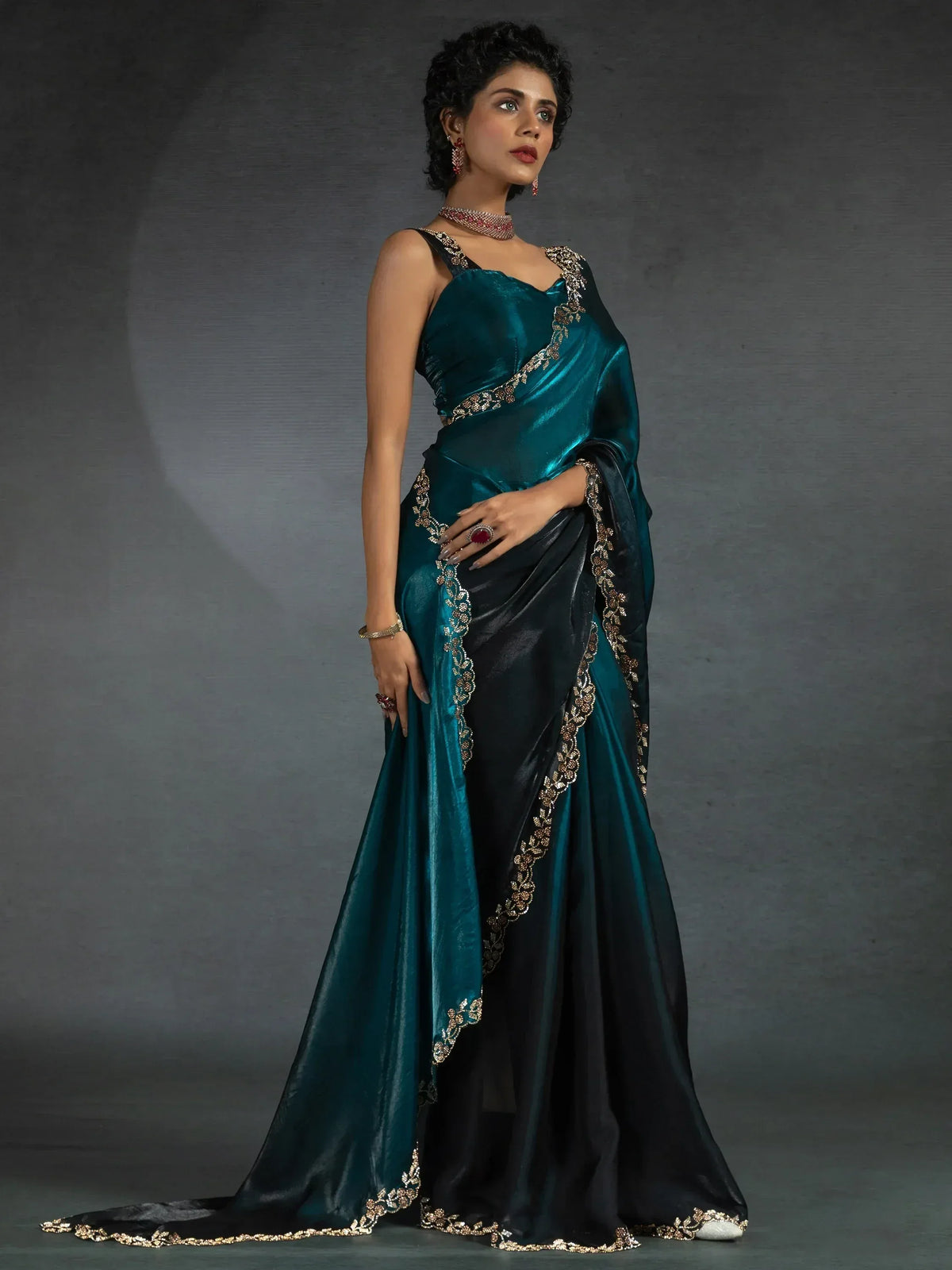 Elegant teal and black saree with gold embroidery, perfect for ethnic occasions