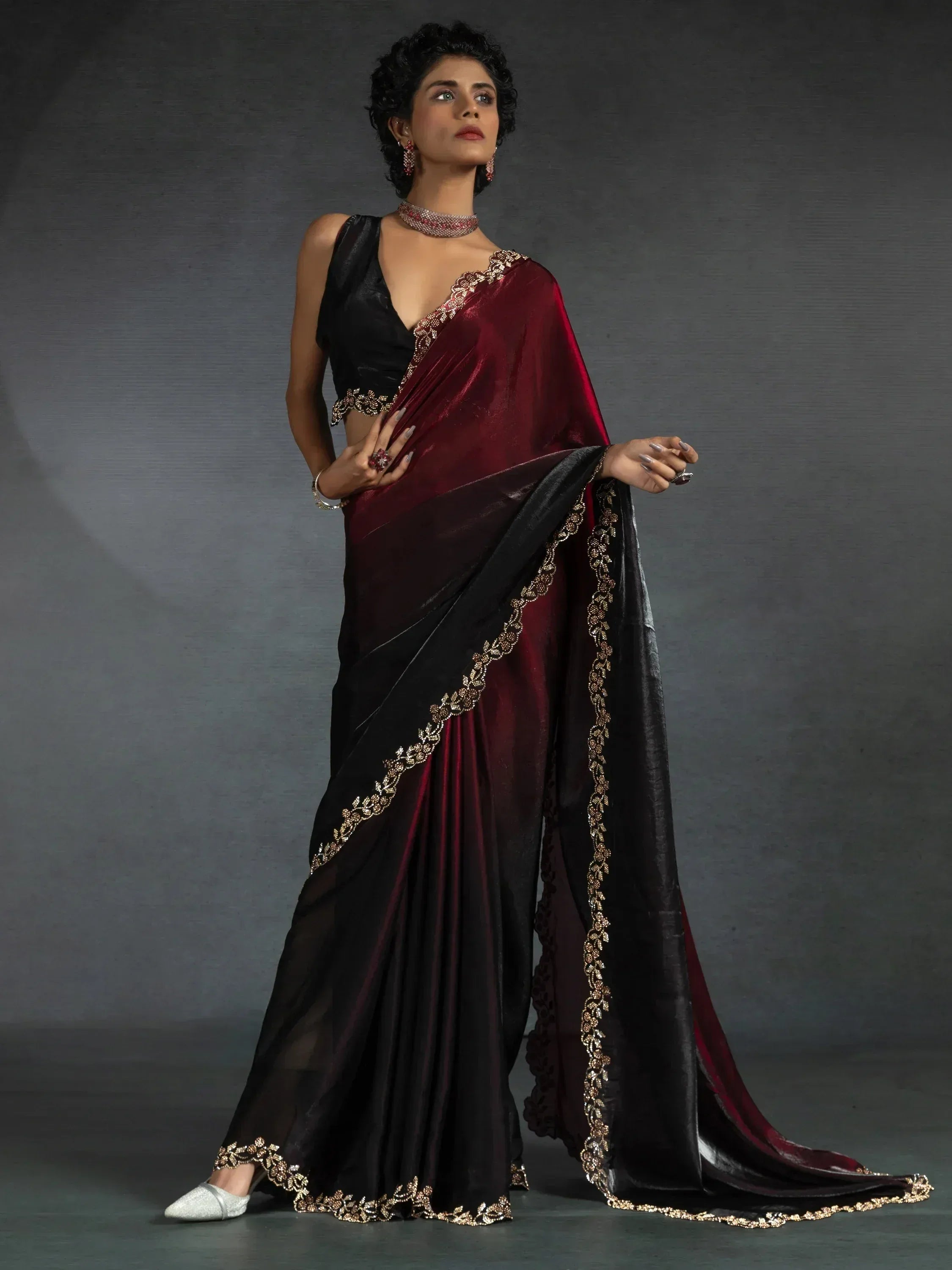 Elegant maroon and black saree with gold embroidery, perfect for Indian ethnic wear occasions.