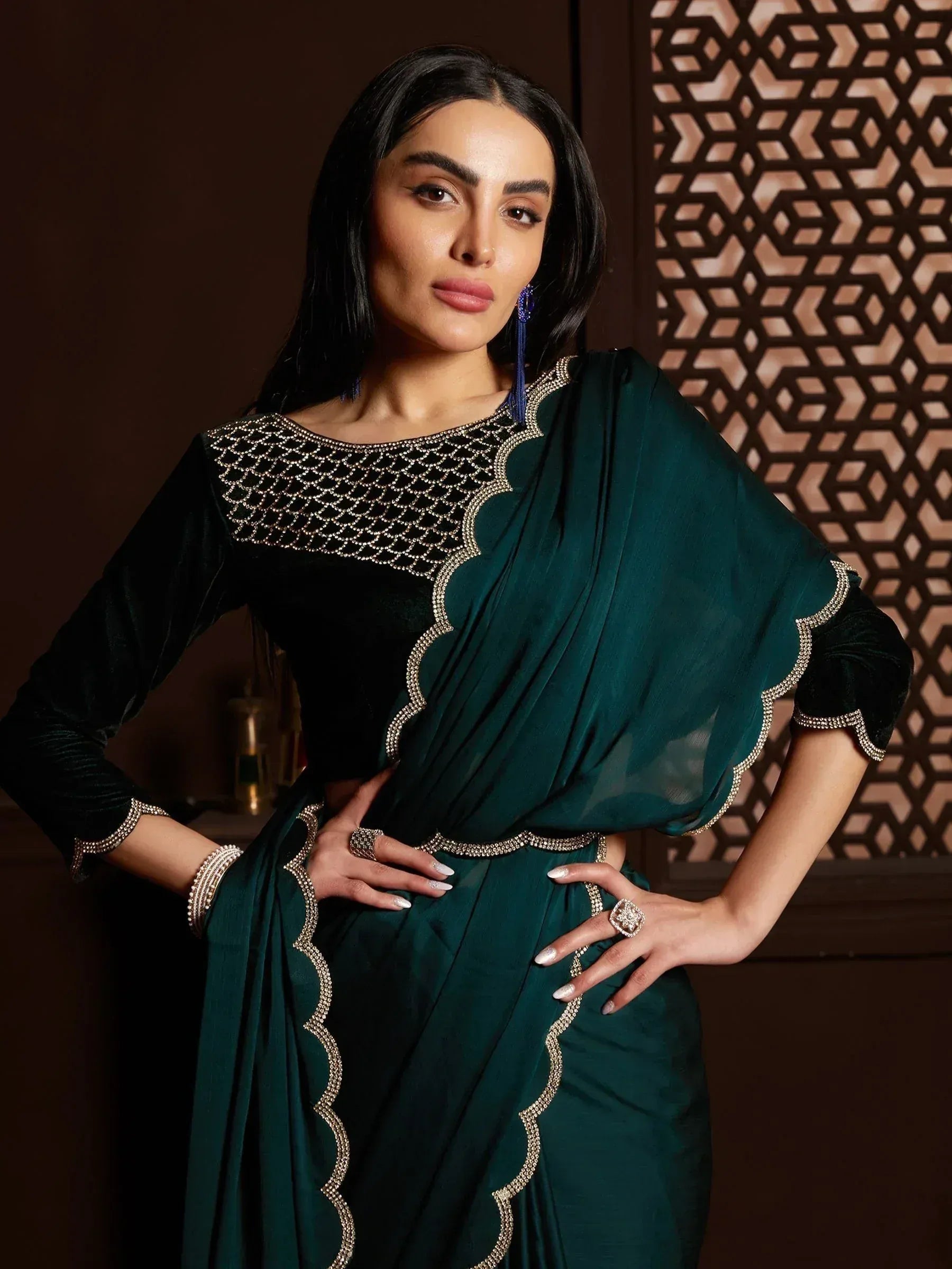 Emerald green designer saree with velvet blouse and intricate gold embroidery, perfect for Indian ethnic occasions