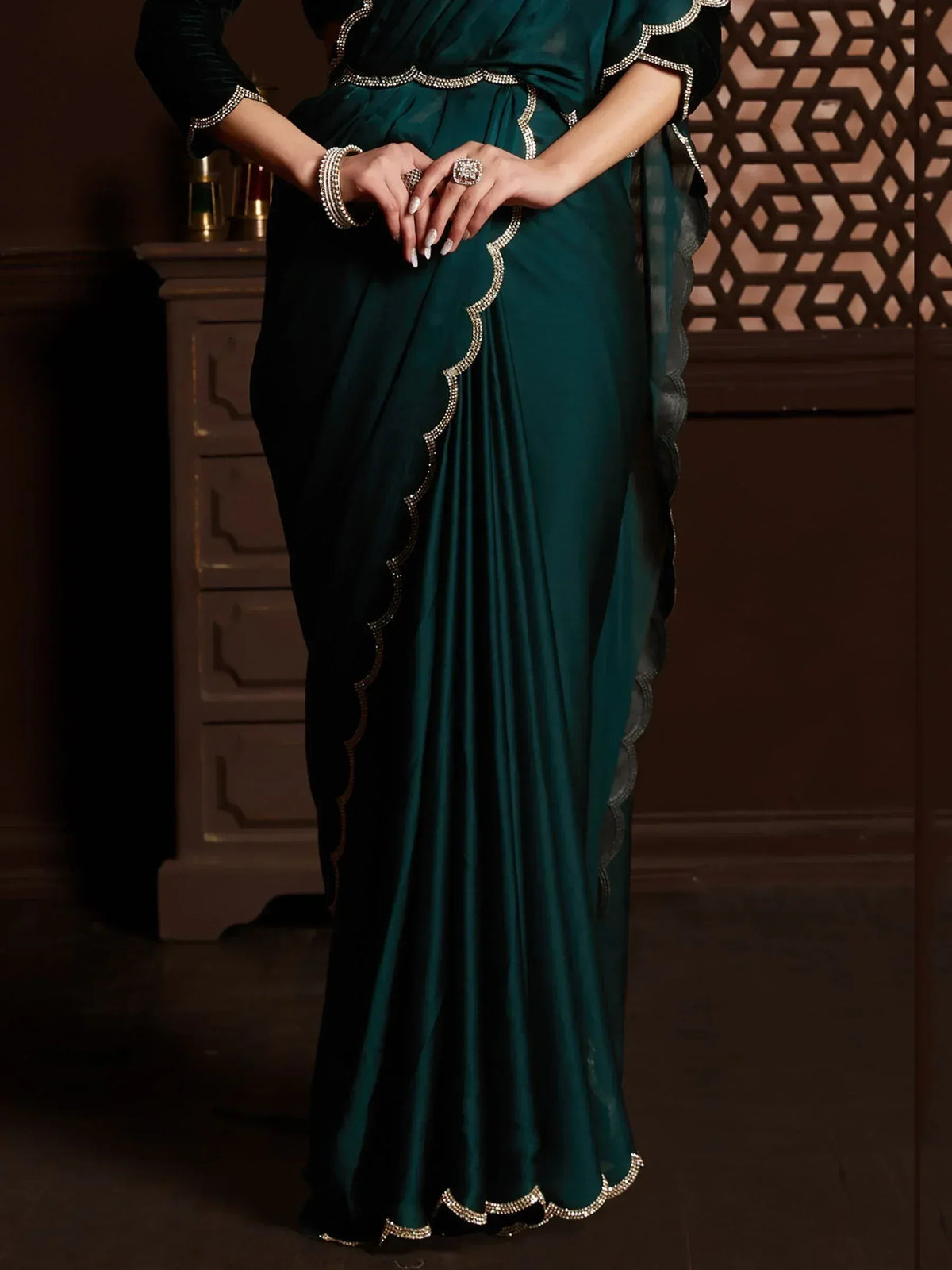 Emerald green saree with scalloped embellished border, perfect for Indian ethnic wear occasions.