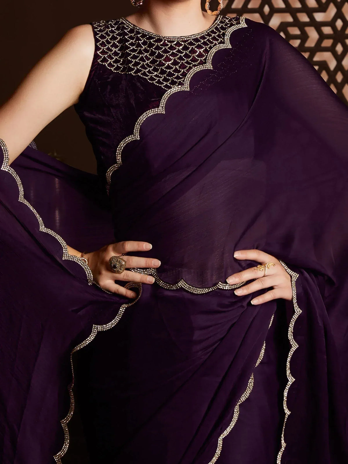 Elegant purple saree with intricate gold embroidery and scalloped neckline, perfect for Indian ethnic occasions.