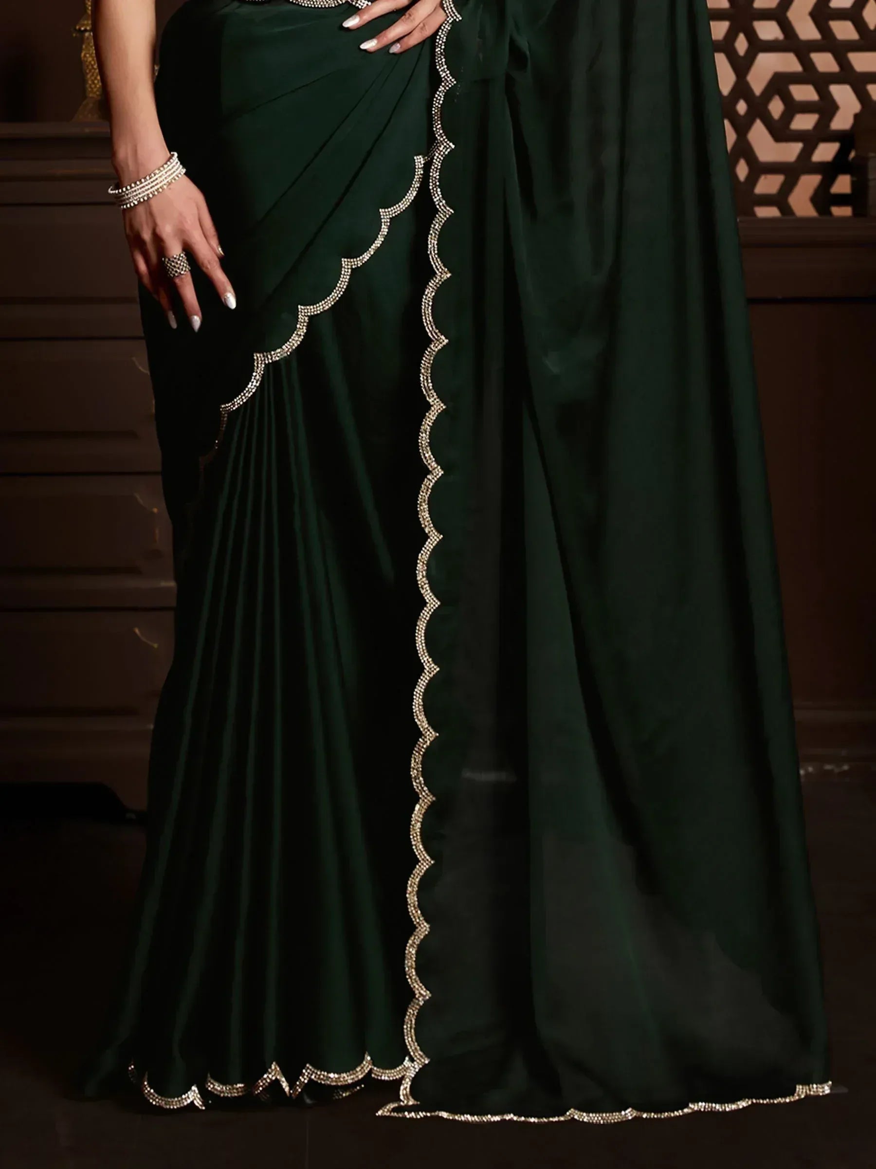 Emerald green saree with scalloped crystal border, elegant Indian ethnic wear for women