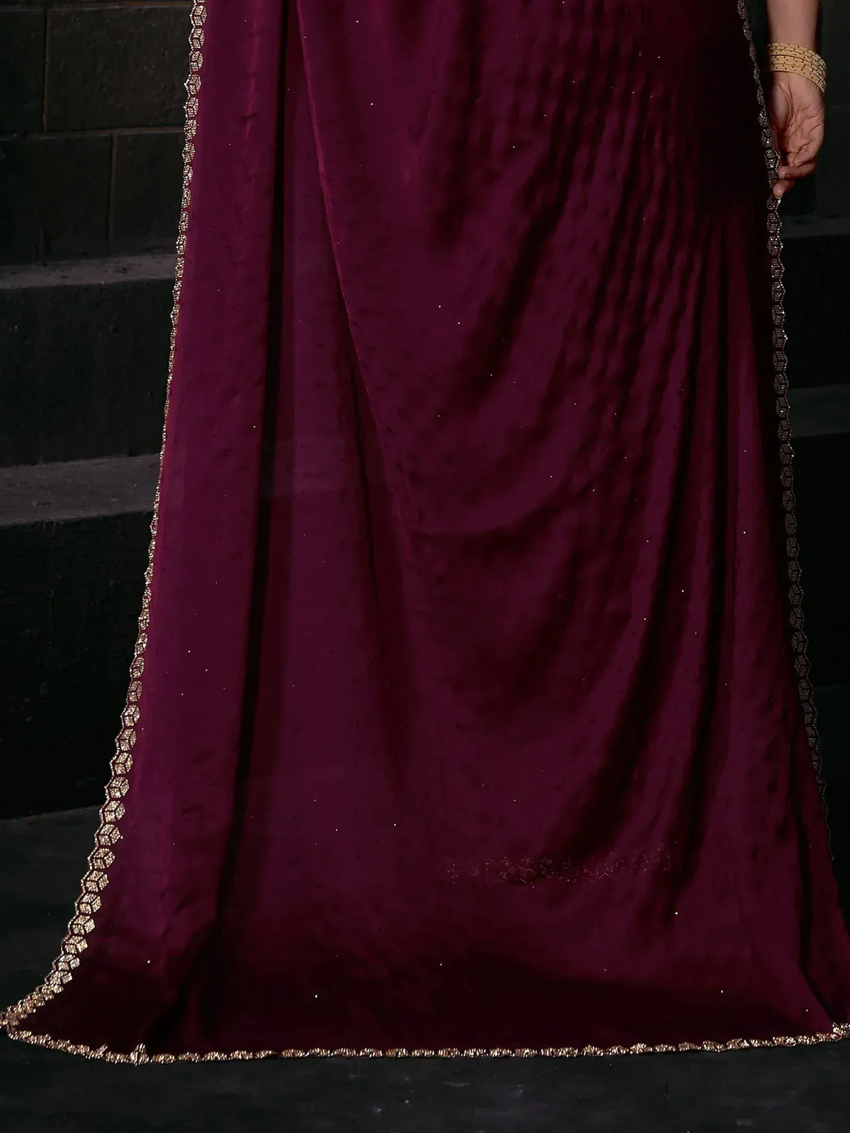 Rich maroon velvet ethnic gown with gold embroidered border, perfect for Indian weddings and festive occasions.
