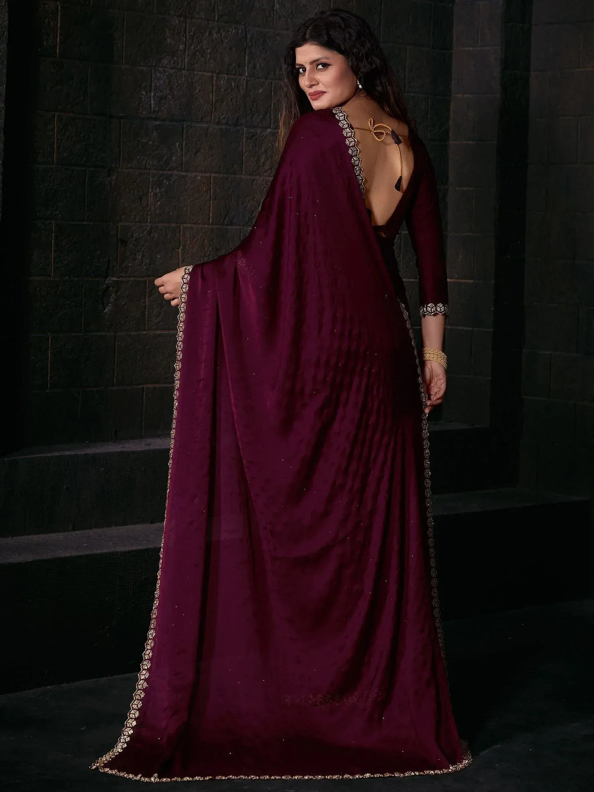 Elegant maroon saree with gold embroidery, backless blouse, and shimmering border for Indian ethnic wear