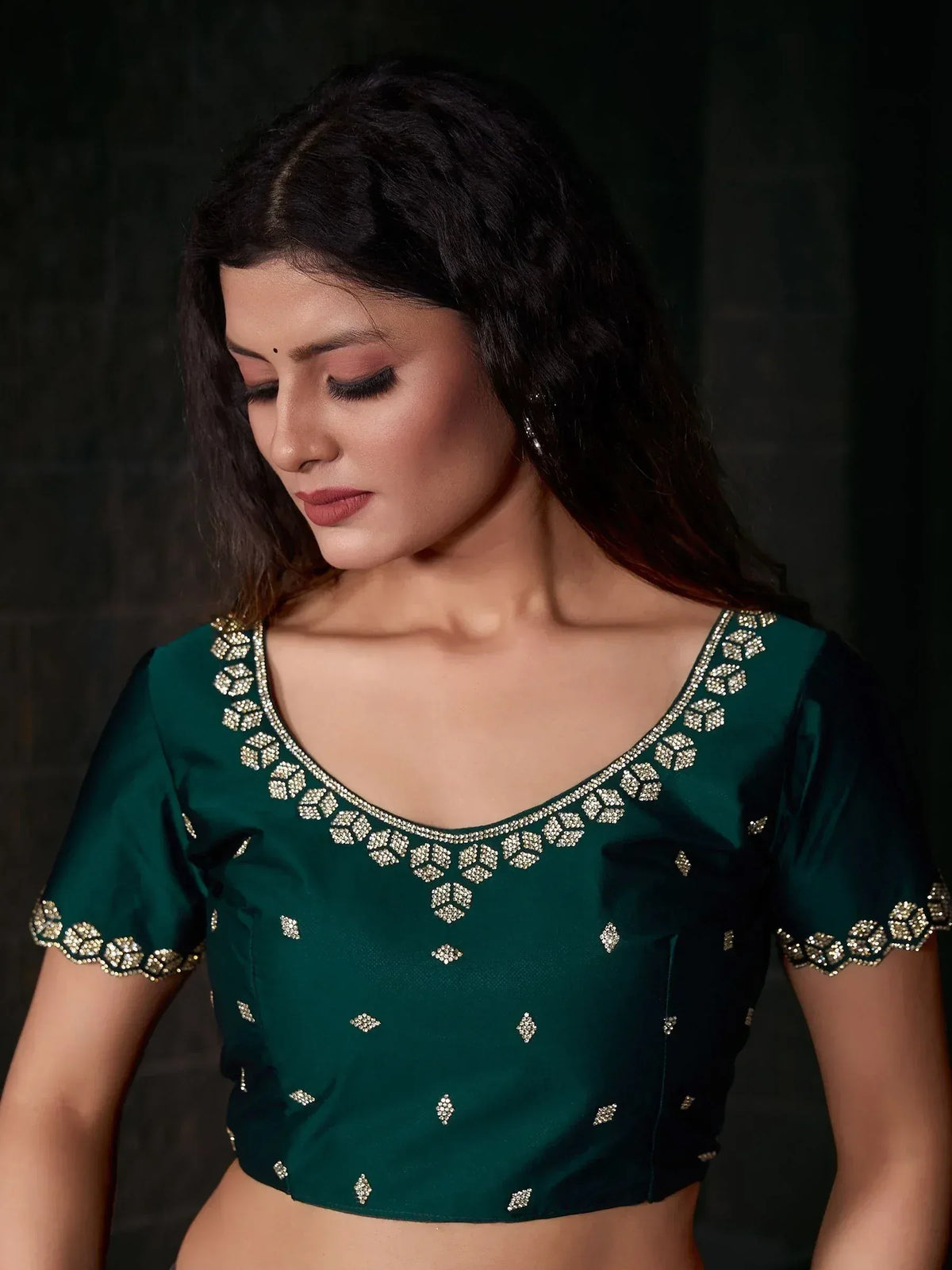 Emerald green designer blouse with gold embroidery, perfect for lehenga choli or saree