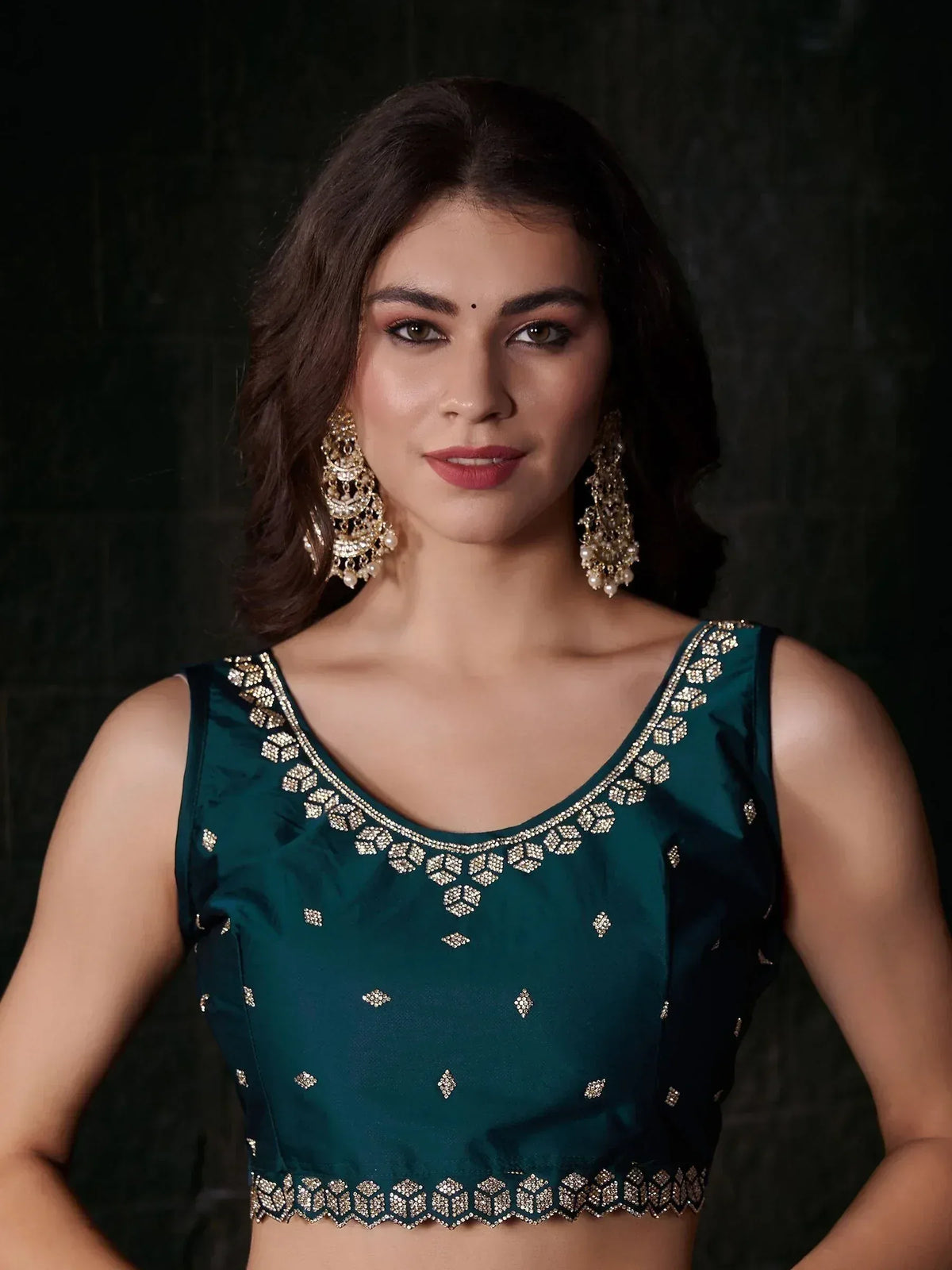 Emerald green embroidered blouse with gold detailing, perfect for Indian ethnic wear and lehenga choli sets.