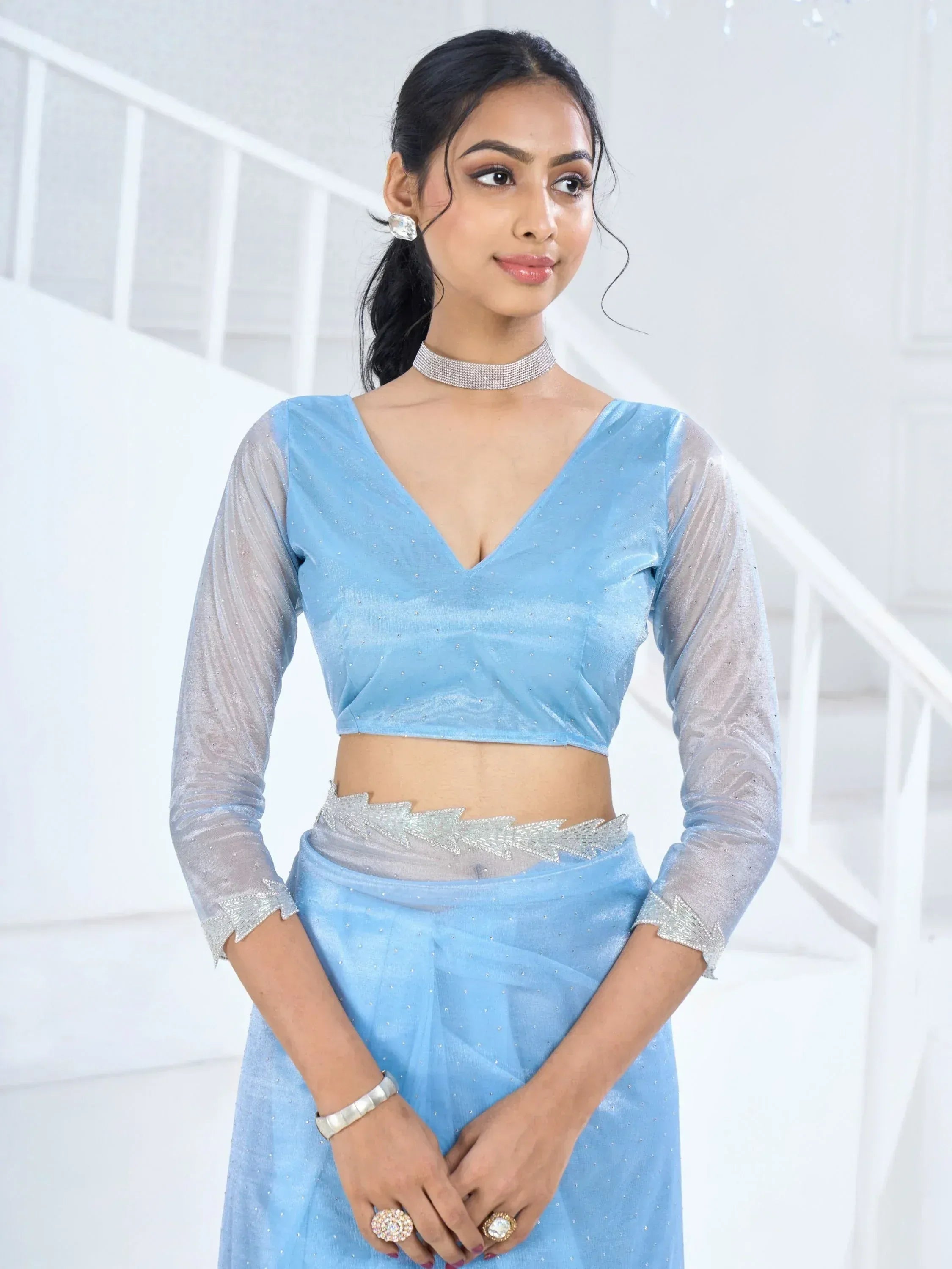 Light blue designer lehenga choli with sheer sleeves and silver embellishments, perfect for ethnic occasions