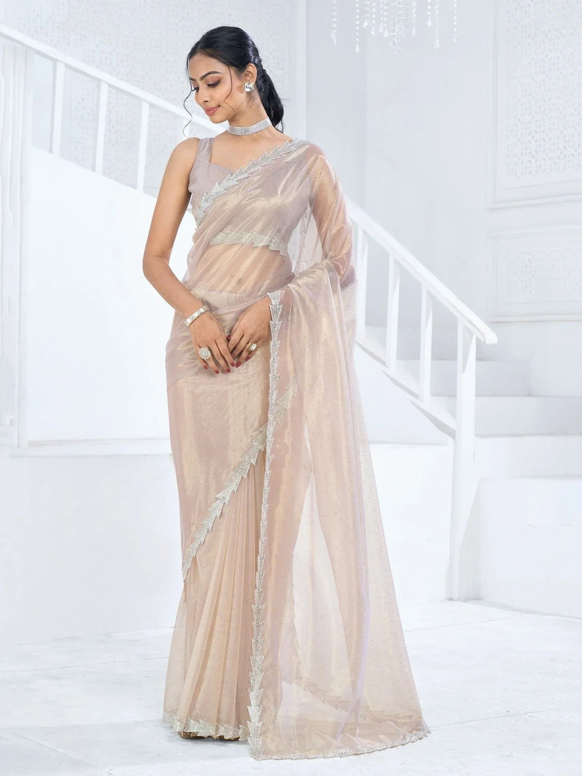 Elegant beige saree with silver embroidery, perfect for Indian ethnic wear events and celebrations.