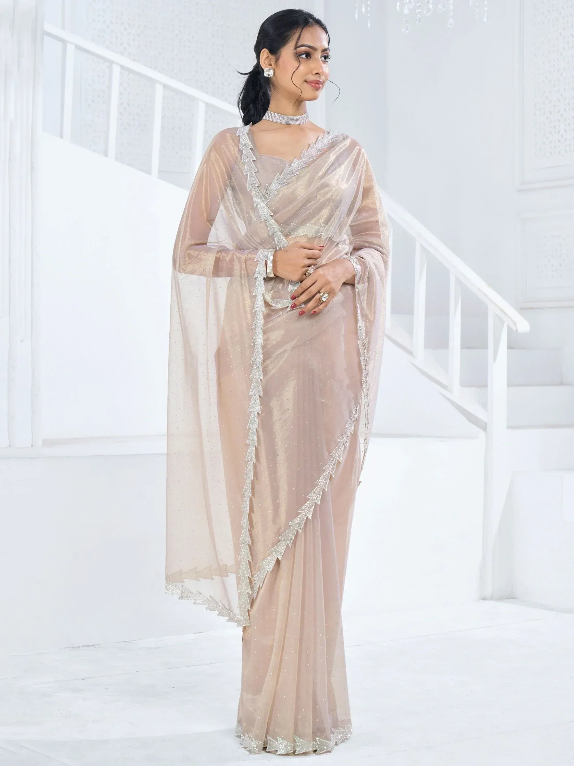 Elegant beige saree with silver zari work, perfect for Indian ethnic occasions and festive events.