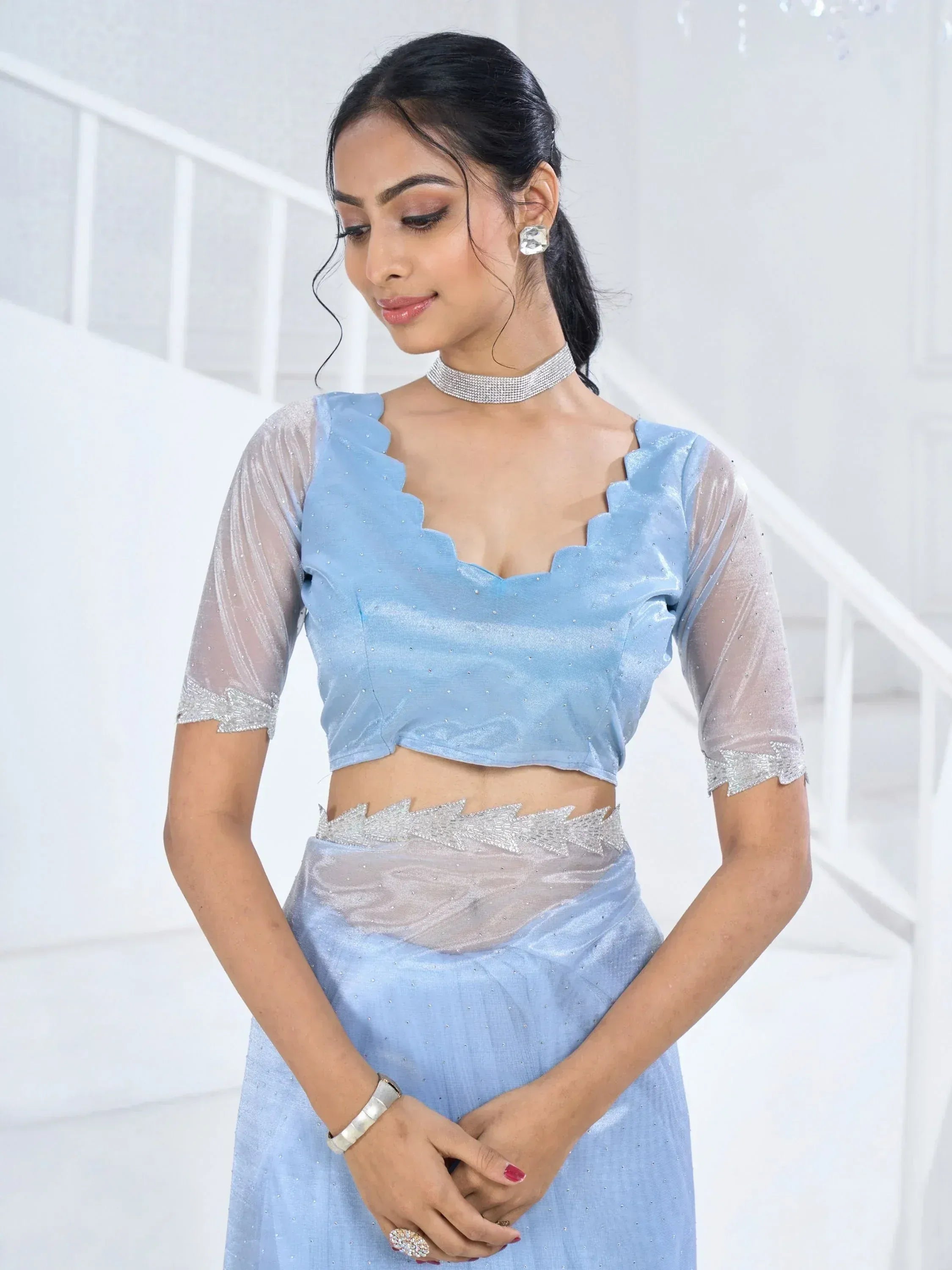 Light blue designer lehenga choli with sheer sleeves and silver embellishments, perfect for ethnic occasions