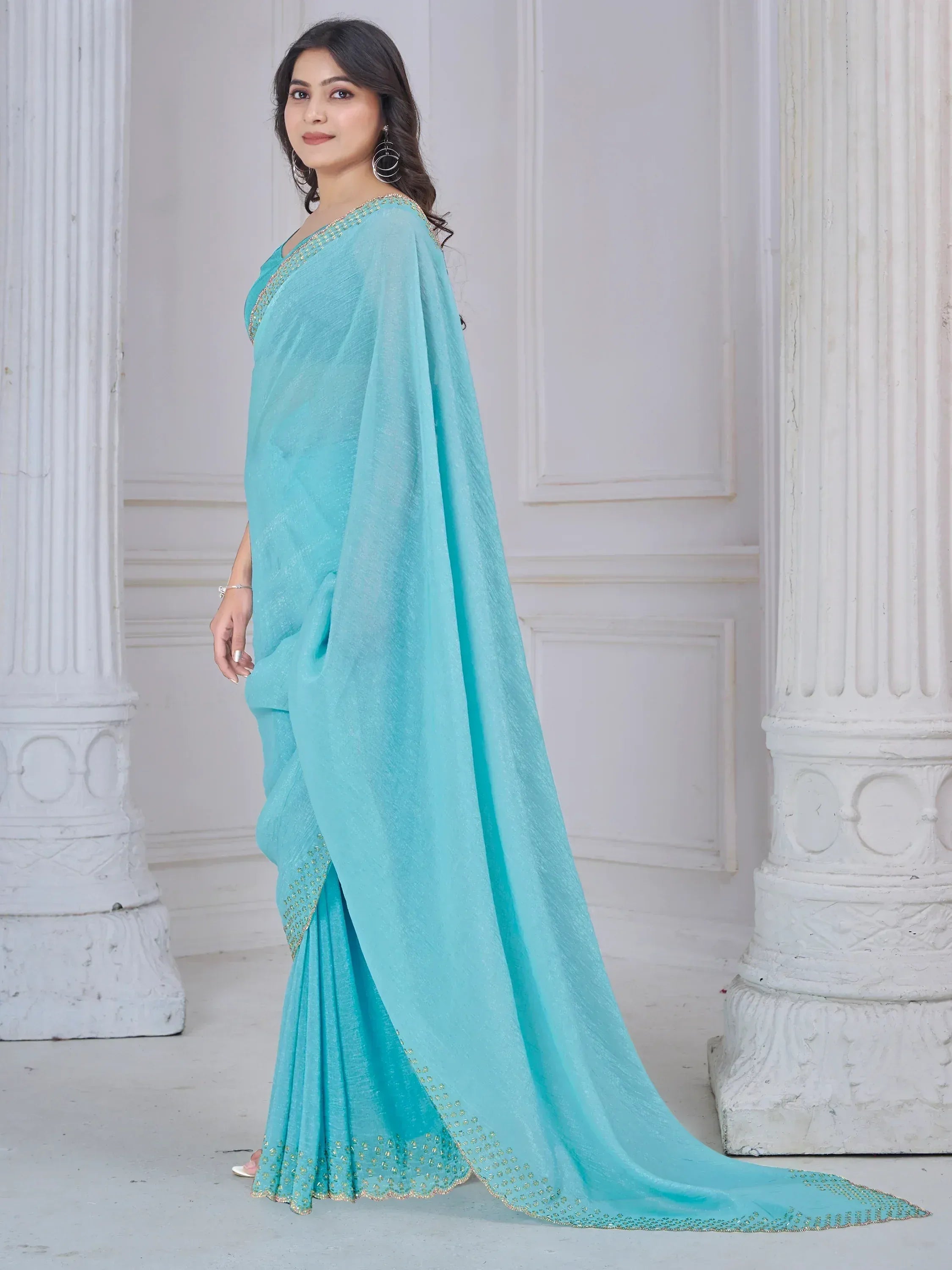 Elegant turquoise saree with golden embroidery, perfect for Indian ethnic wear occasions.