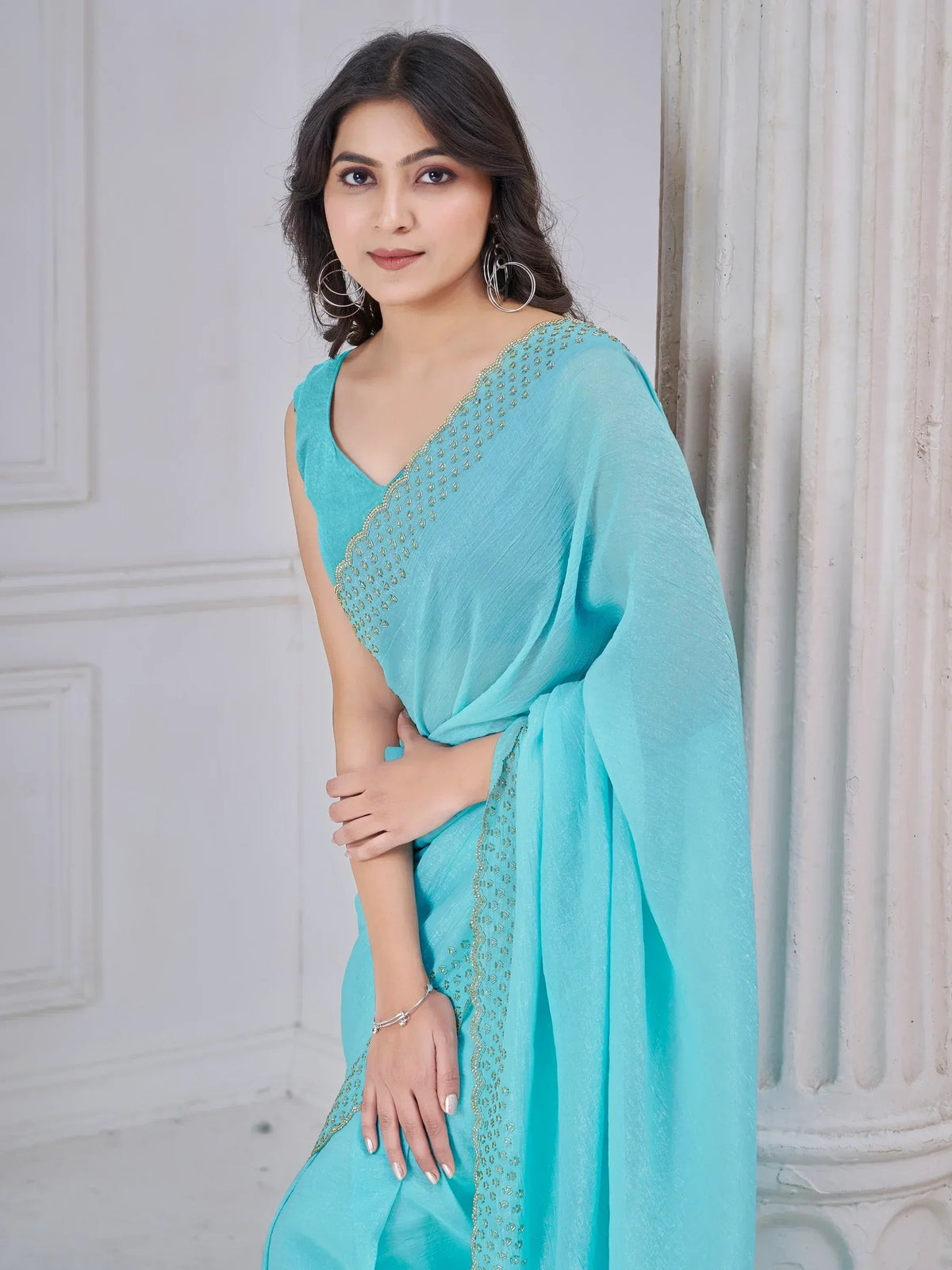 Elegant turquoise saree with golden embroidery, perfect for ethnic occasions