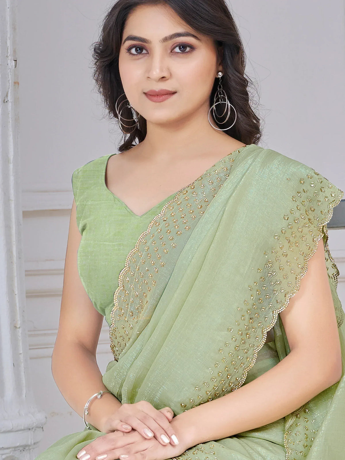 Elegant light green saree with golden embroidery, perfect for Indian ethnic wear occasions.