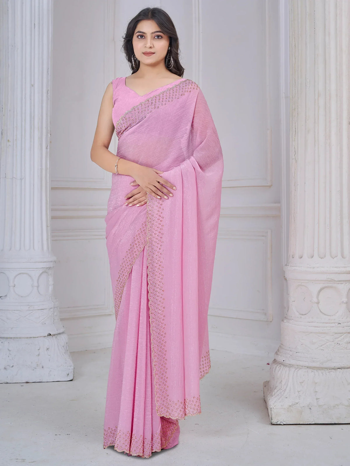 Elegant pink saree with golden embroidery, perfect for ethnic occasions and festive wear.